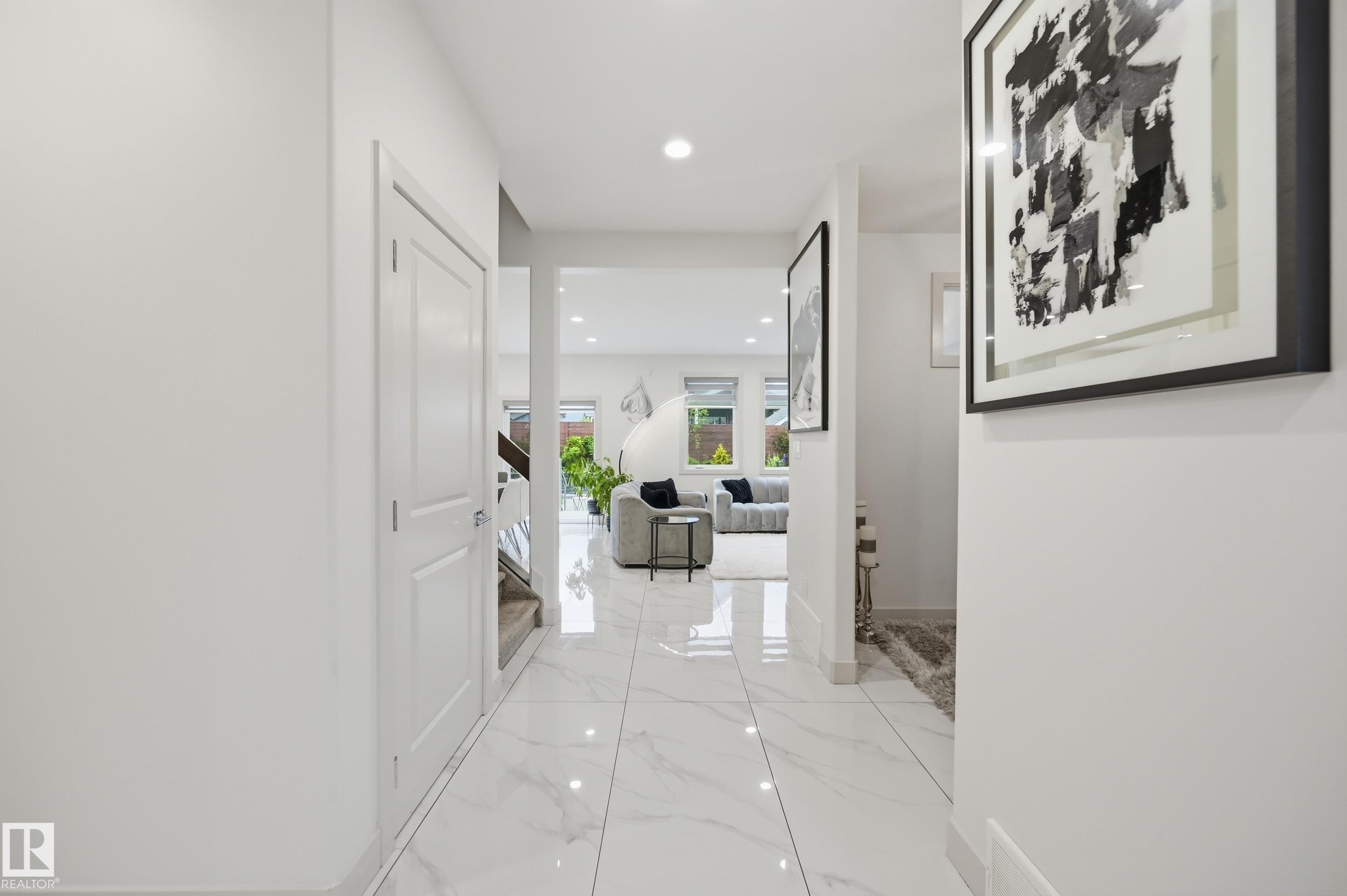 Bright entryway featuring large format white tile flooring with subtle veining and recessed lighting - 76 Jacobs Close, St. Albert, AB