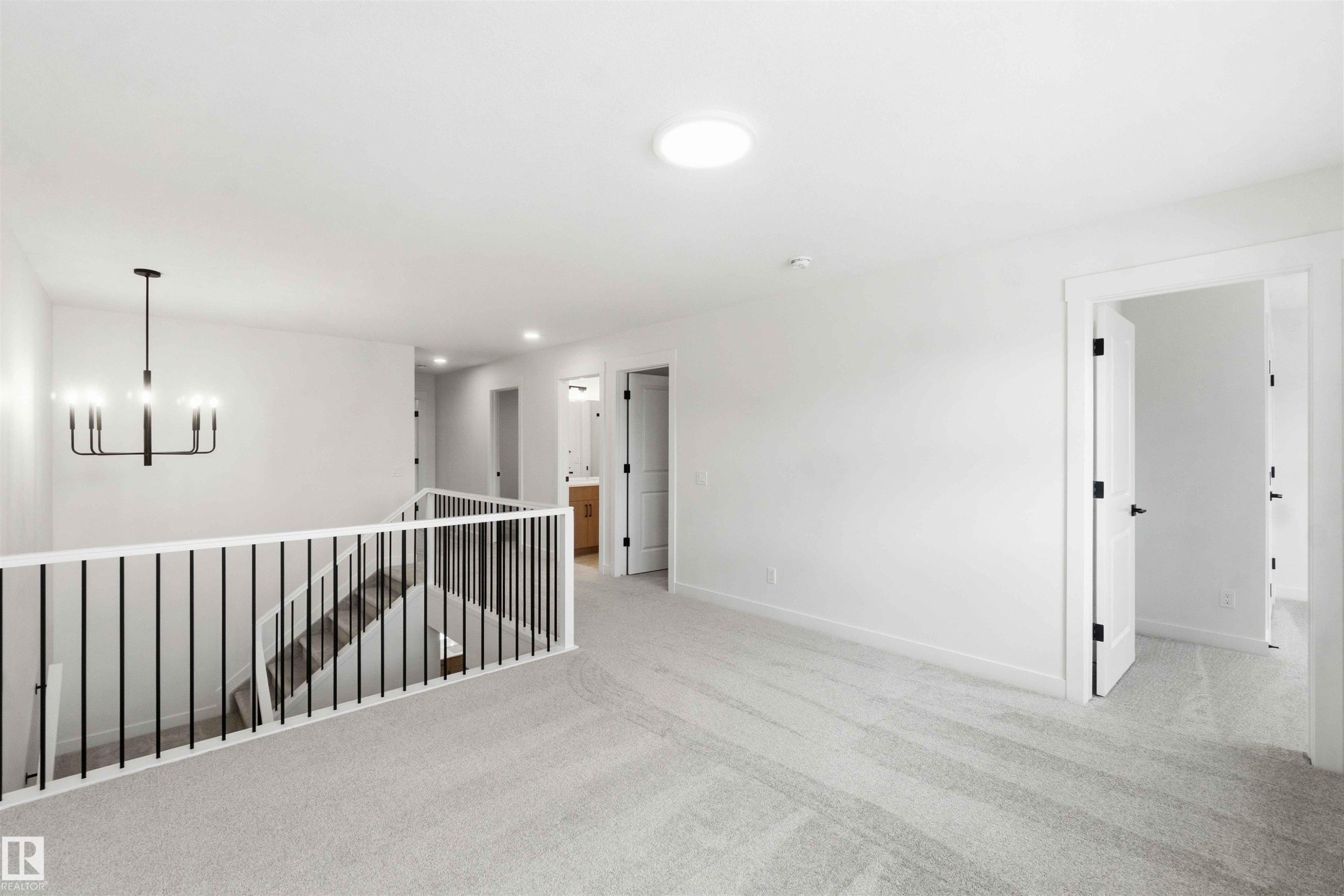 Upper level landing featuring light gray carpet flooring and white walls - 1085 Cristall Crescent Sw, Edmonton, AB - Indoor Photo Showing Other Room