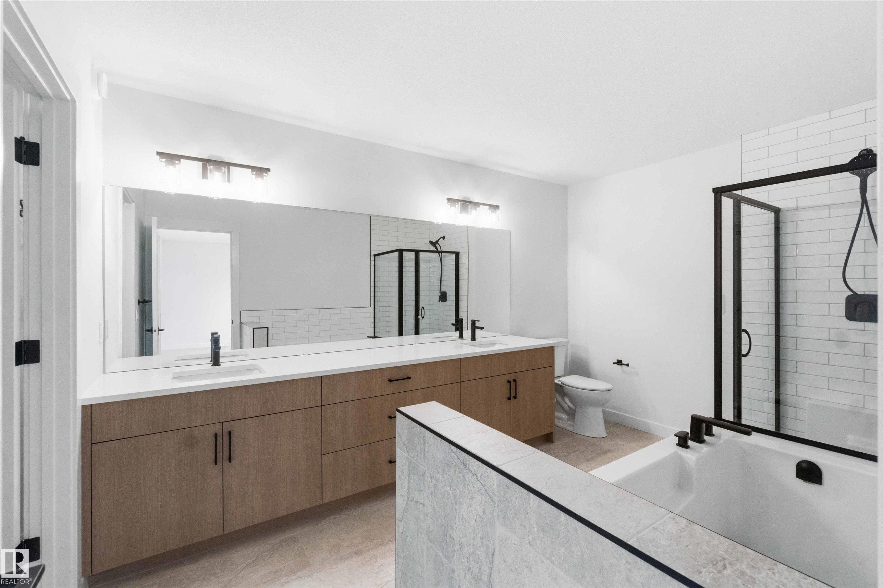 Dual vanity with light wood-finish cabinetry and white countertops - 1085 Cristall Crescent Sw, Edmonton, AB - Indoor Photo Showing Bathroom