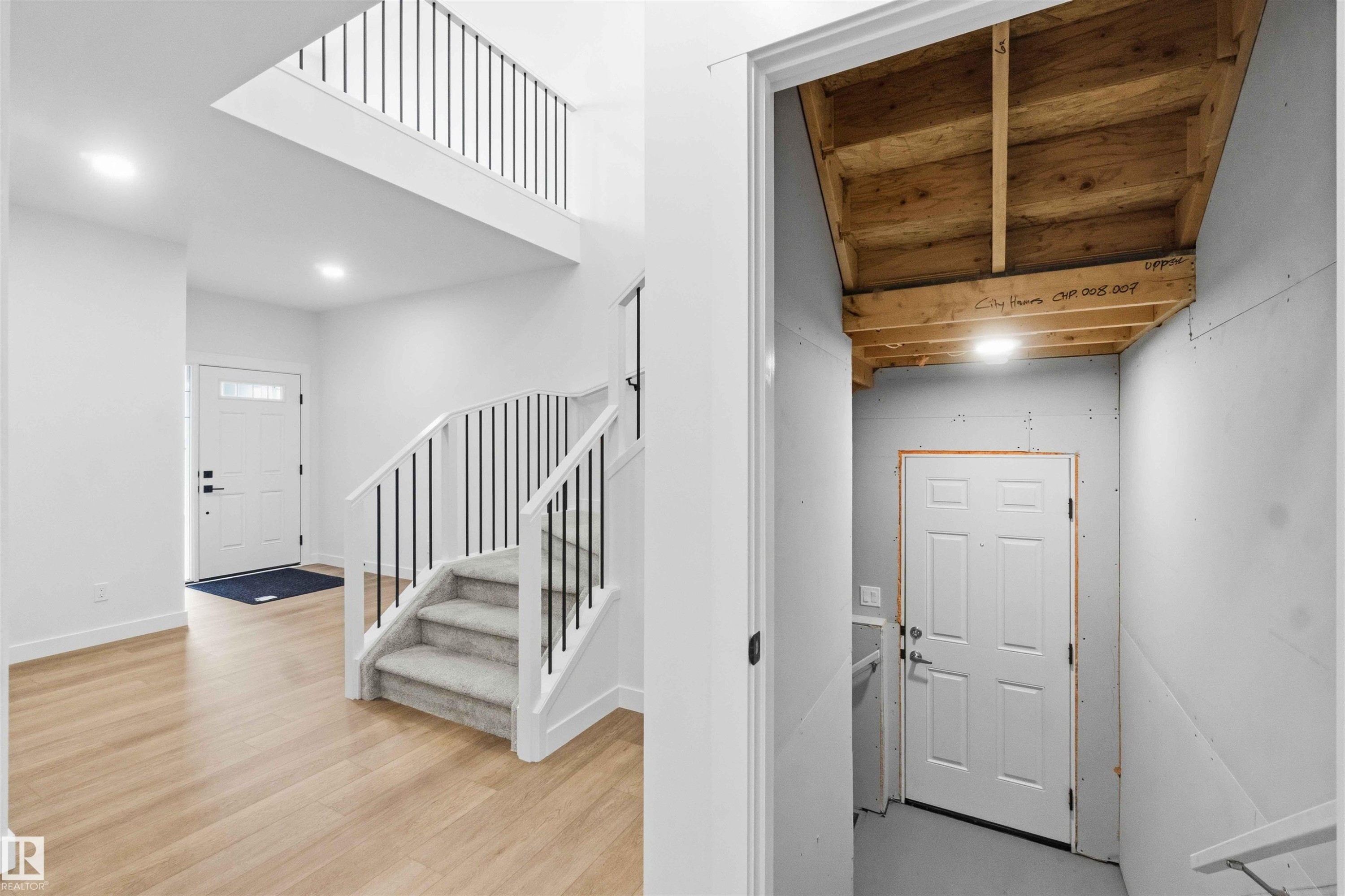 Foyer featuring light wood-finish flooring, a contemporary staircase with black metal balusters, and a second-story open landing - 1085 Cristall Crescent Sw, Edmonton, AB - Indoor Photo Showing Other Room