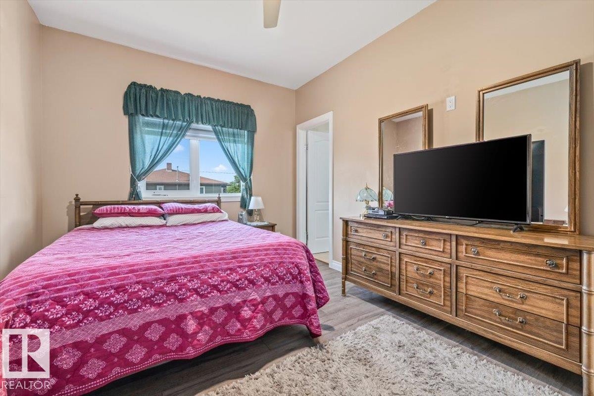 Room featuring wood-finish flooring, a neutral wall color, and a window with natural light - 4708 47A Avenue, Onoway, AB