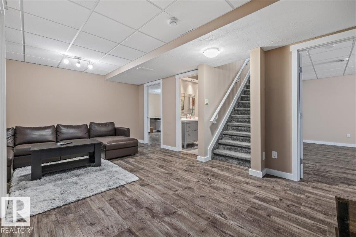 Spacious lower level featuring wood-finish flooring, recessed lighting, and a drop ceiling - 4708 47A Avenue, Onoway, AB