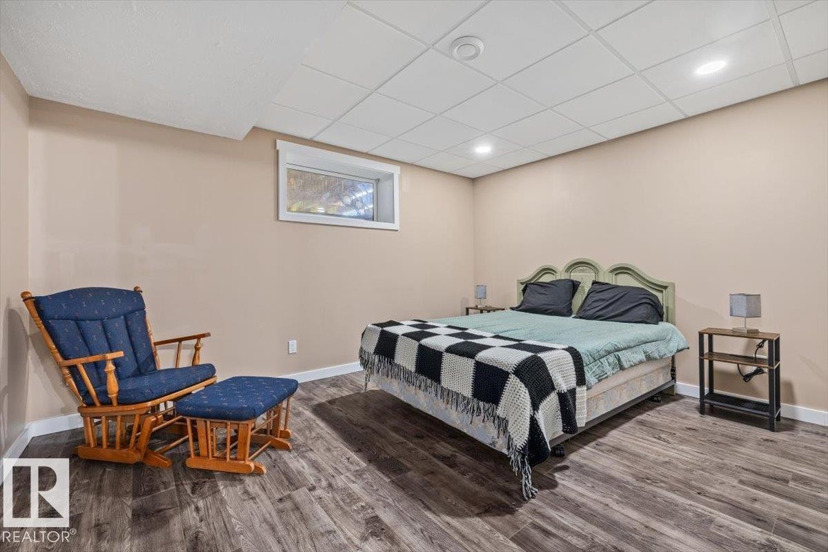 Bedroom featuring wood-finish flooring, neutral wall tones, and recessed lighting - 4708 47A Avenue, Onoway, AB