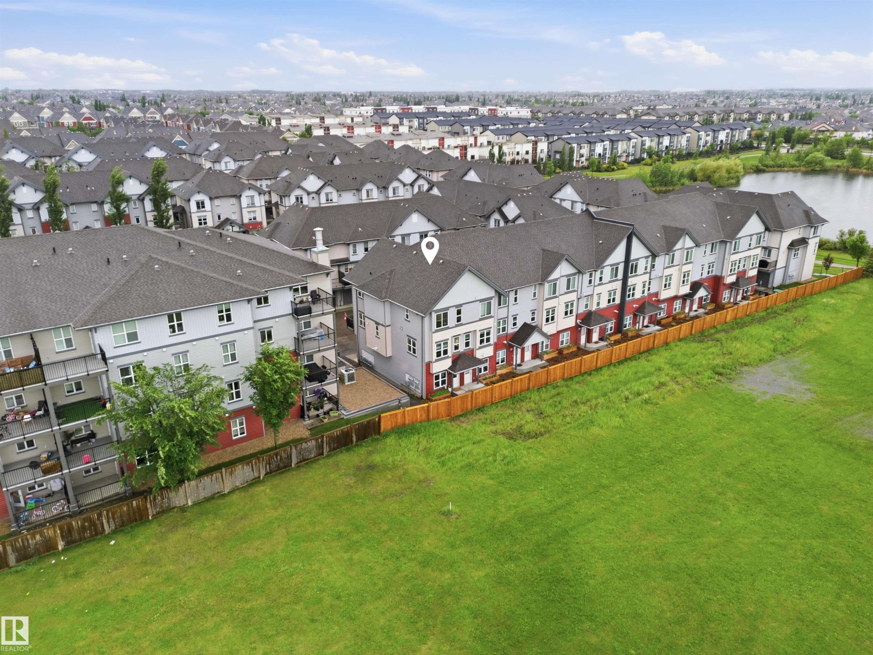 Contemporary townhome community featuring a private fenced yard and a waterside location - 64 655 Watt Boulevard, Edmonton, AB