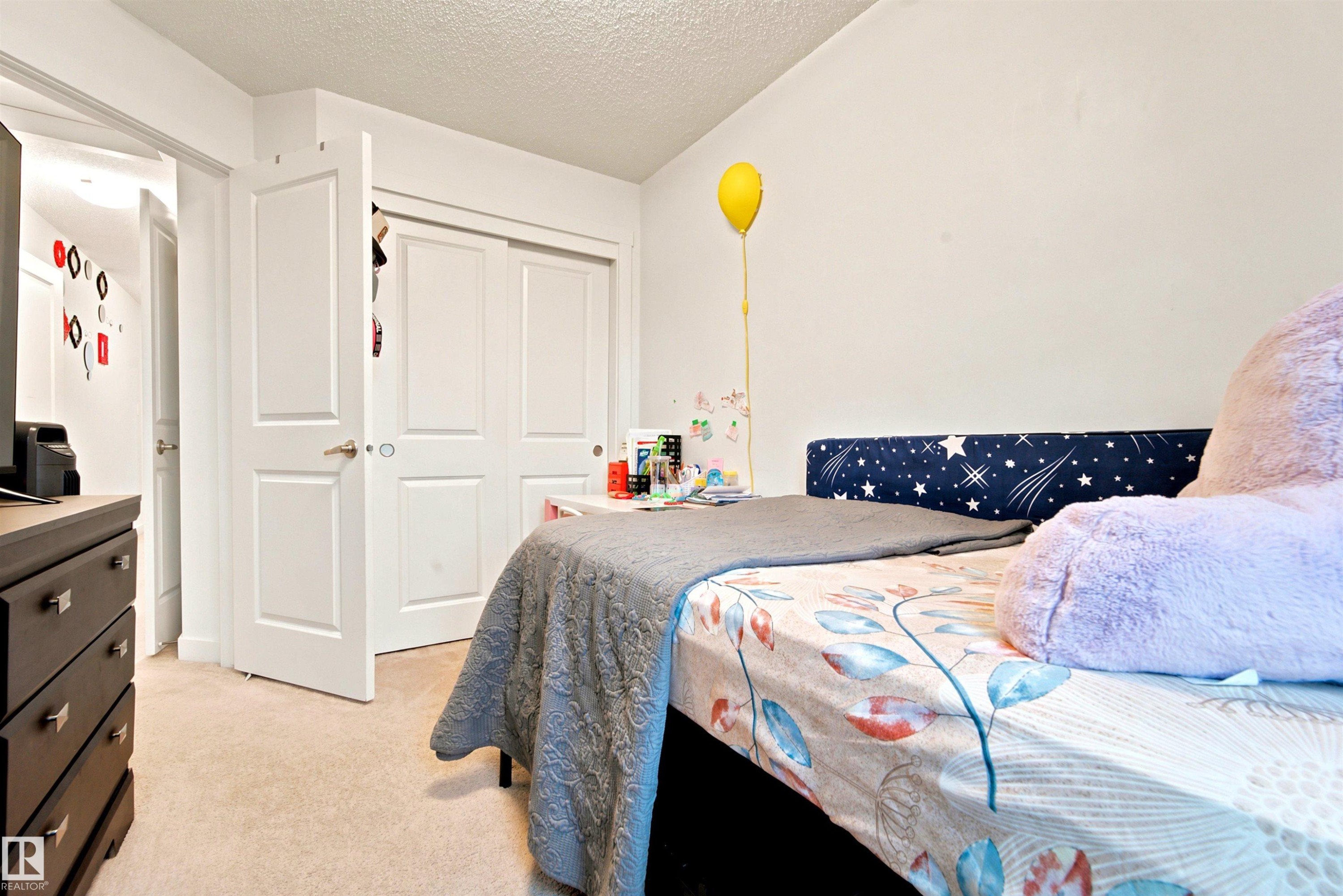Bedroom featuring light-toned carpeting and white walls - 64 655 Watt Boulevard, Edmonton, AB