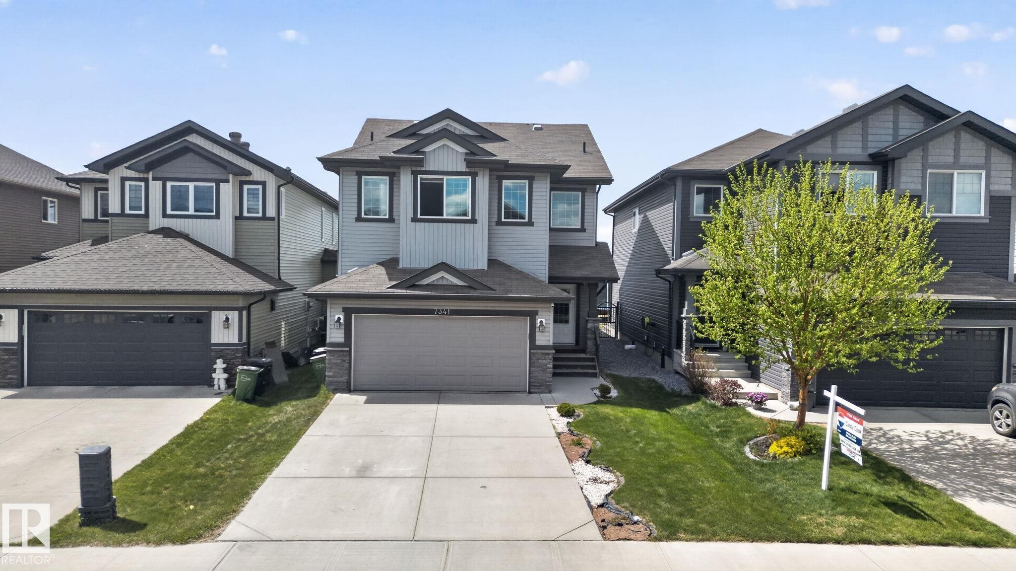 Modern residential exterior featuring light blue siding with dark trim accents - 7341 Armour Crescent, Edmonton, AB - Outdoor With Facade