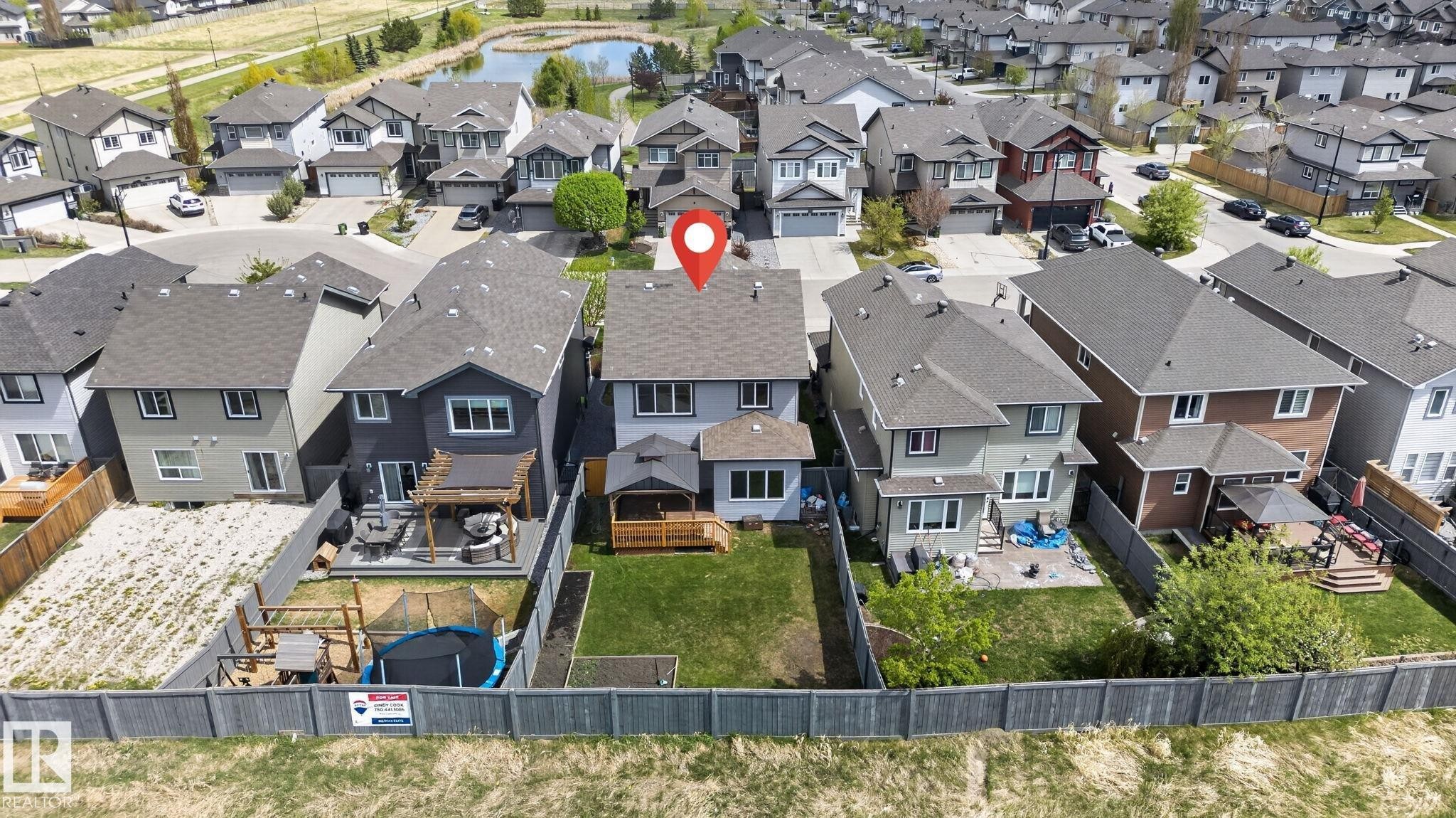 Rear exterior featuring a spacious backyard, a multi-level deck, and a shed - 7341 Armour Crescent, Edmonton, AB - Outdoor