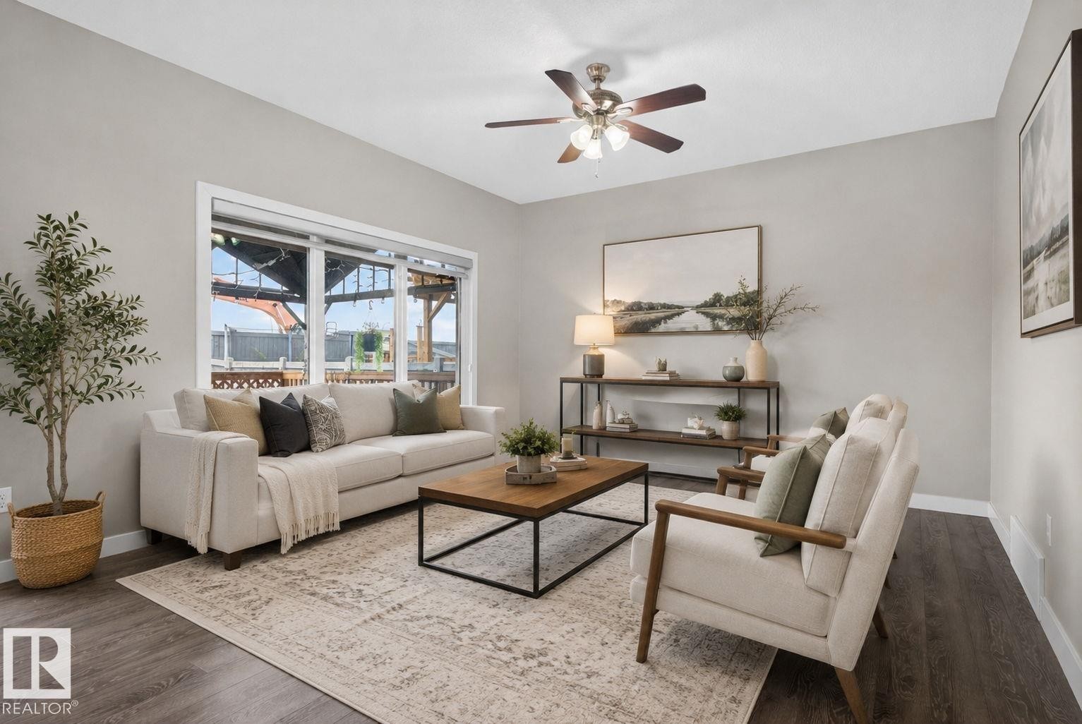 Spacious living area featuring a large window, dark wood-finish flooring, light grey walls, and a ceiling fan with integrated lighting - 7341 Armour Crescent, Edmonton, AB - Indoor Photo Showing Living Room