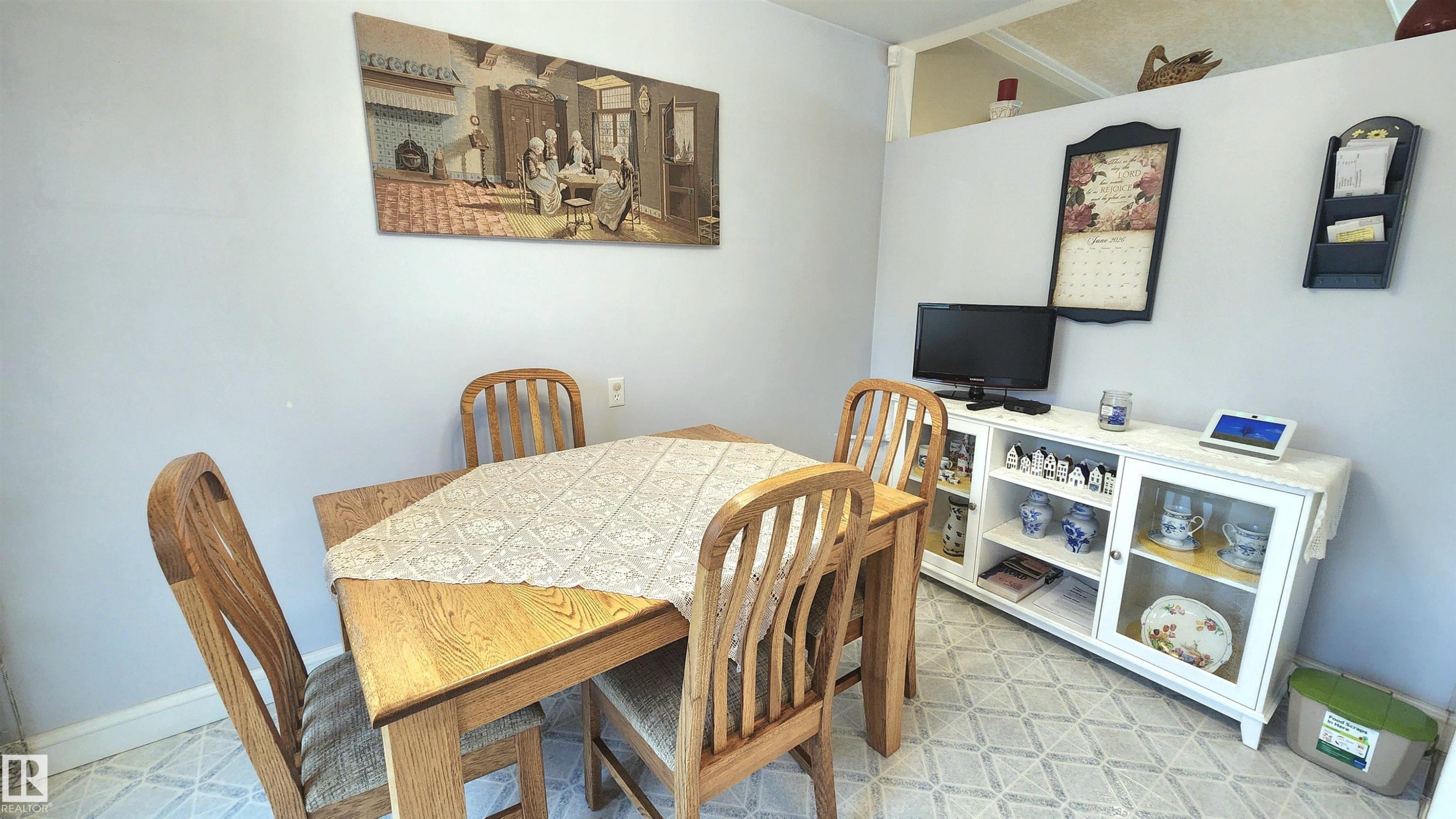 Dining area featuring patterned floor tiles and light gray walls - 13307 Delwood Road, Edmonton, AB
