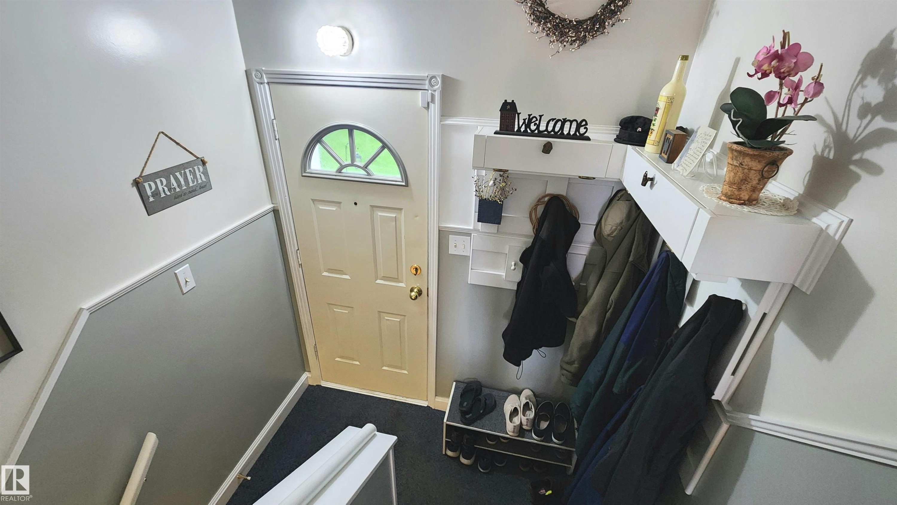 Entryway featuring a white door with an arched glass panel and brass hardware - 13307 Delwood Road, Edmonton, AB