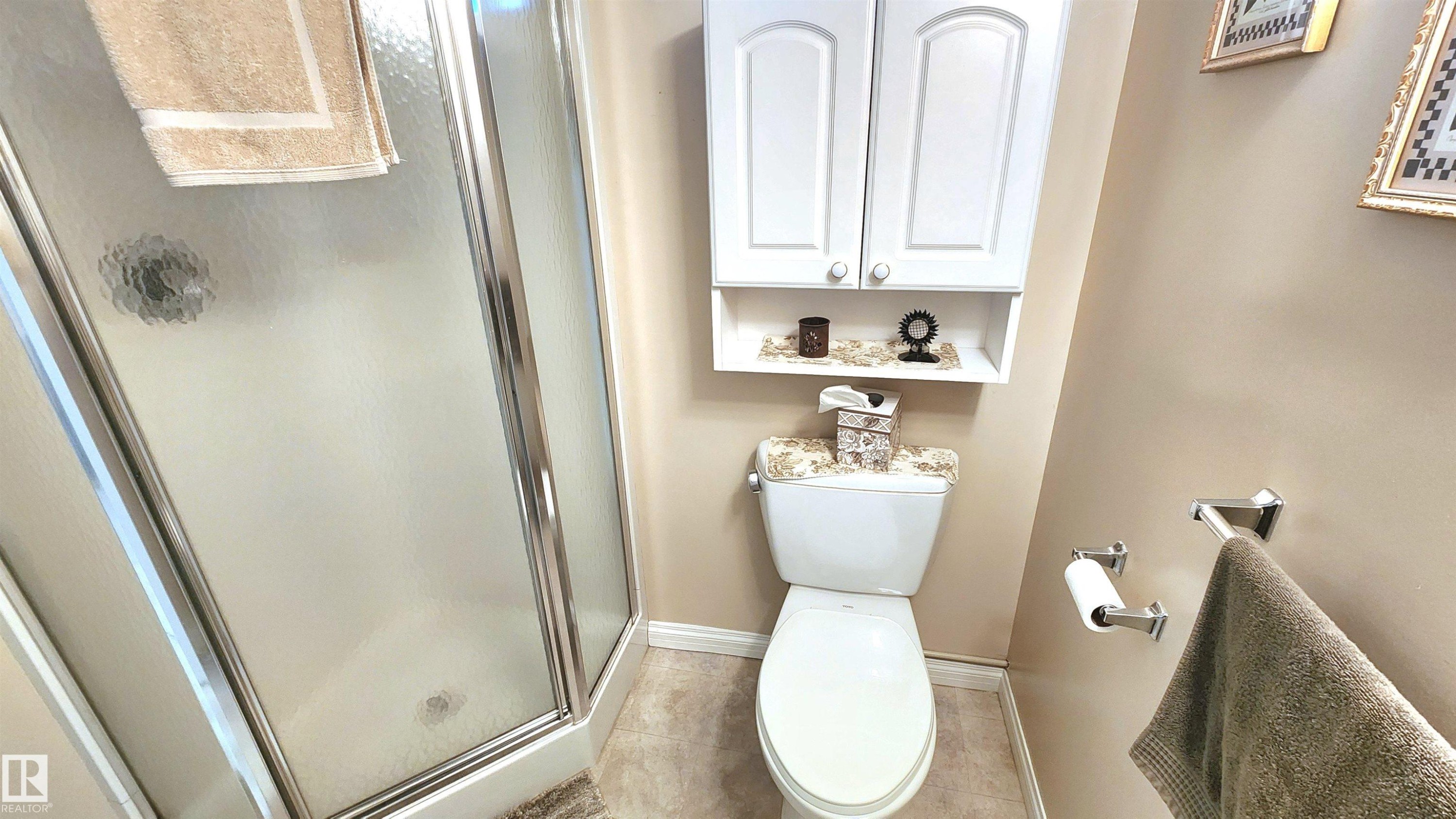 Corner shower enclosure with frosted glass panels and chrome trim - 13307 Delwood Road, Edmonton, AB