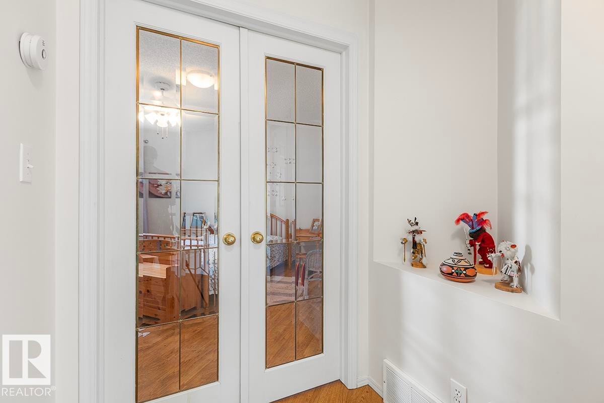 White French doors with gold-finish grilles and round brass knobs - 44 9630 176 Street, Edmonton, AB