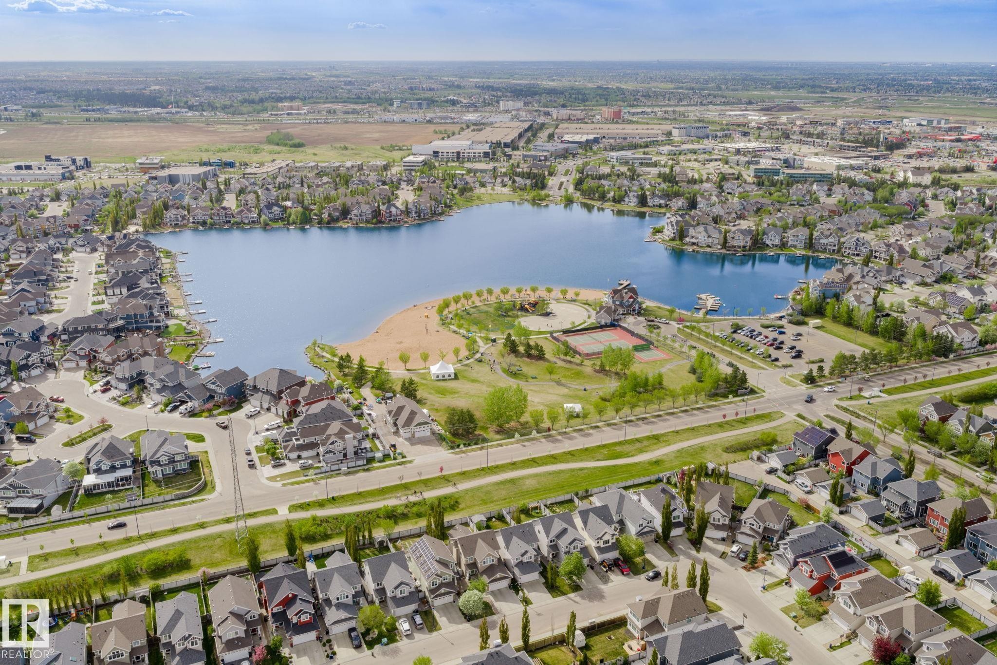 Expansive lakeside community featuring numerous residential properties surrounding a prominent body of water - 7118 19A, Edmonton, AB - Outdoor With Body Of Water With View