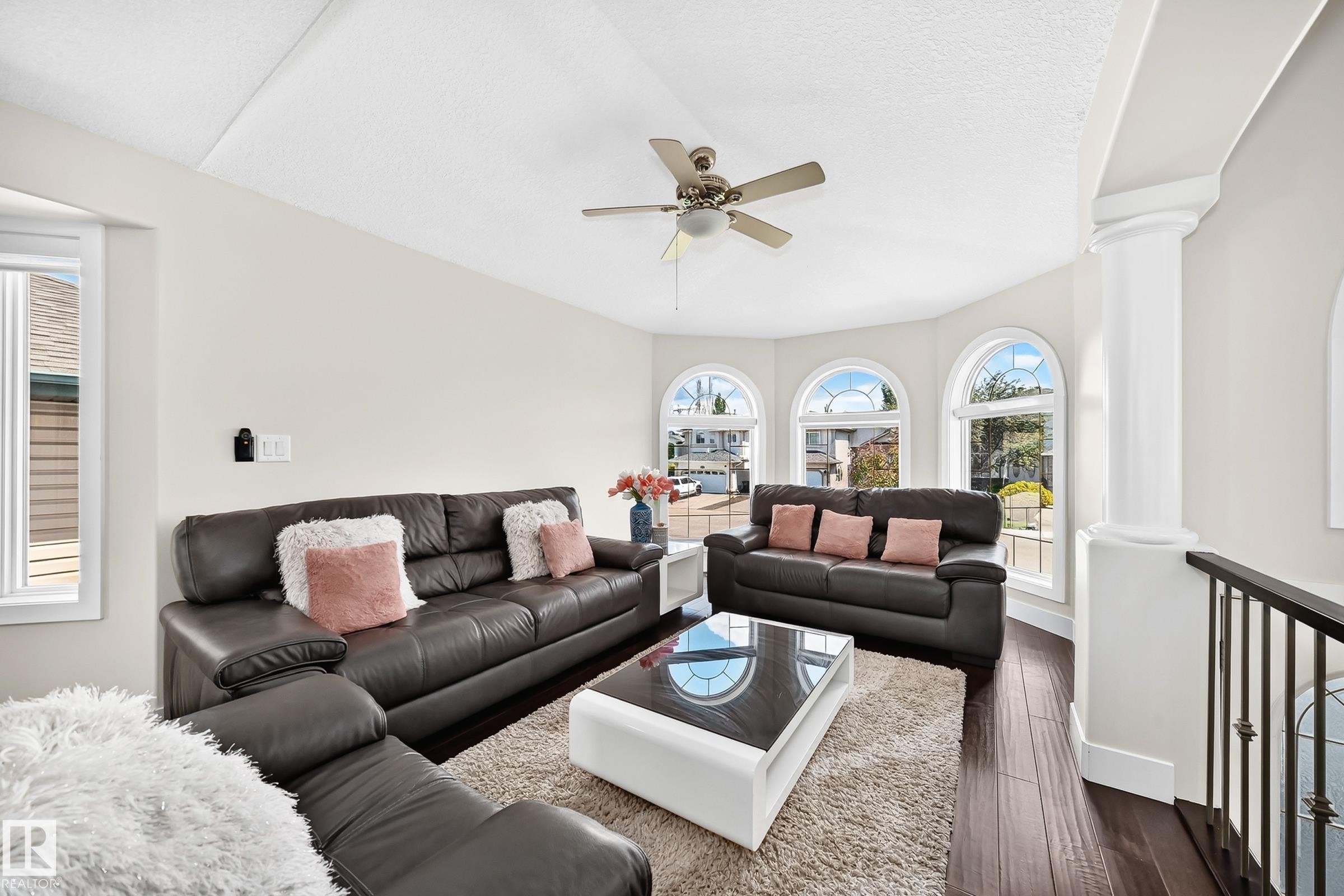 Living area featuring a vaulted ceiling and dark wood-finish flooring - 16124 76 Street, Edmonton, AB