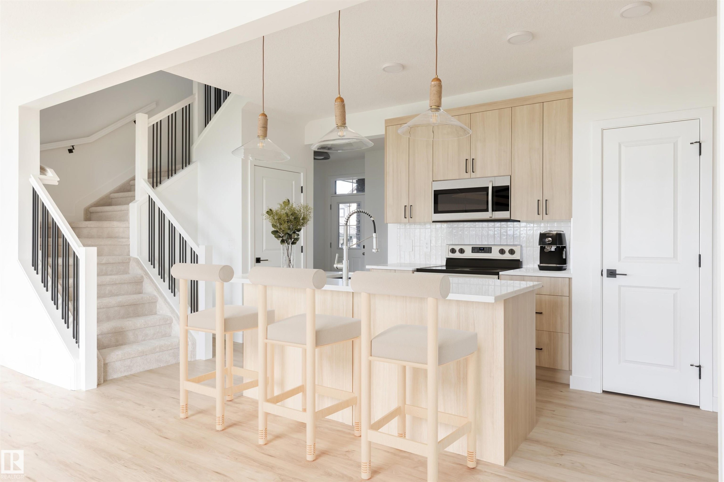 Modern kitchen featuring light wood-finish cabinetry, stainless steel appliances, and a white subway tile backsplash - 47 Chartres Close, St. Albert, AB