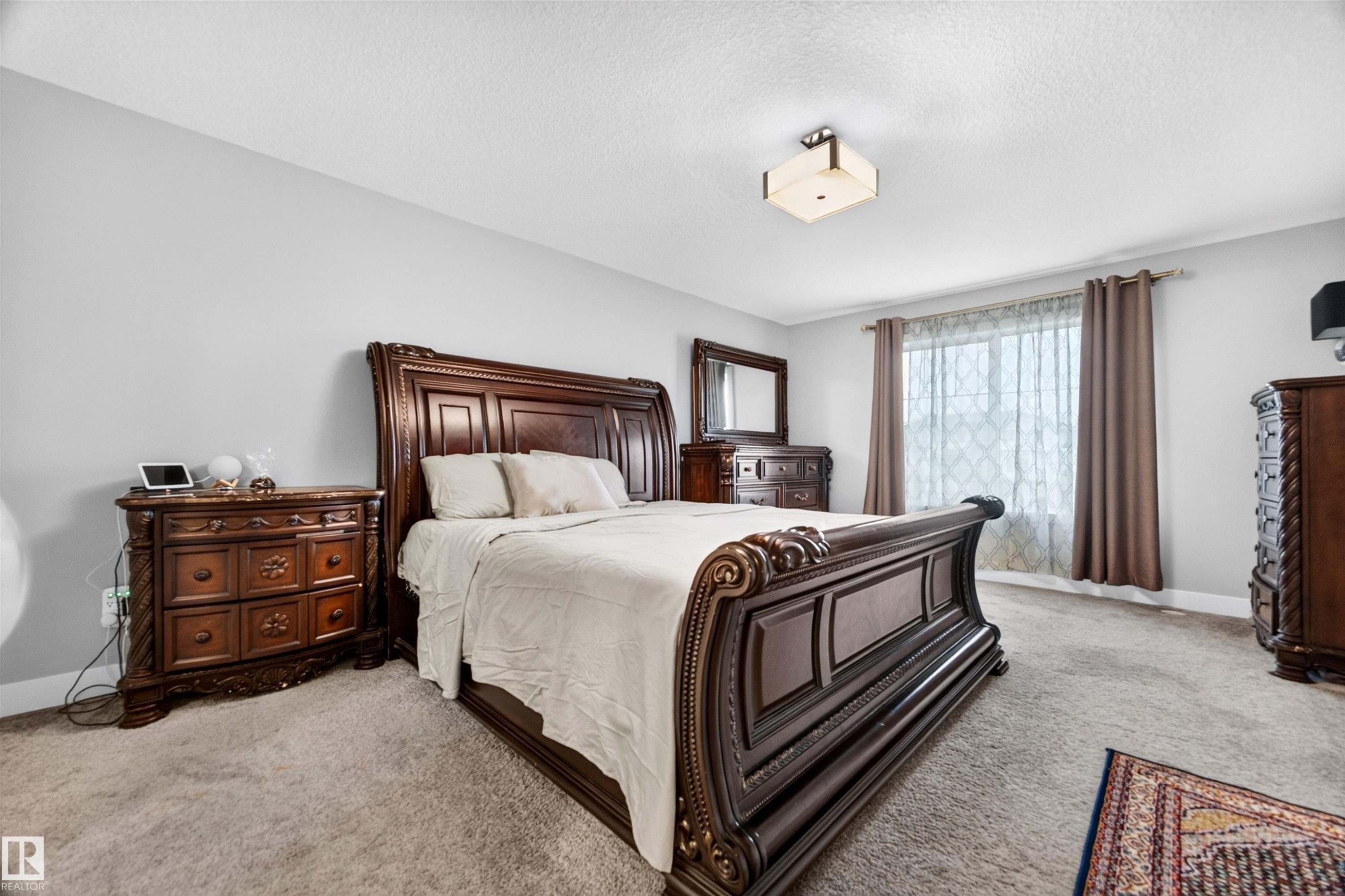 Spacious room featuring light gray wall paint and carpeted flooring - 1603 158 Street, Edmonton, AB