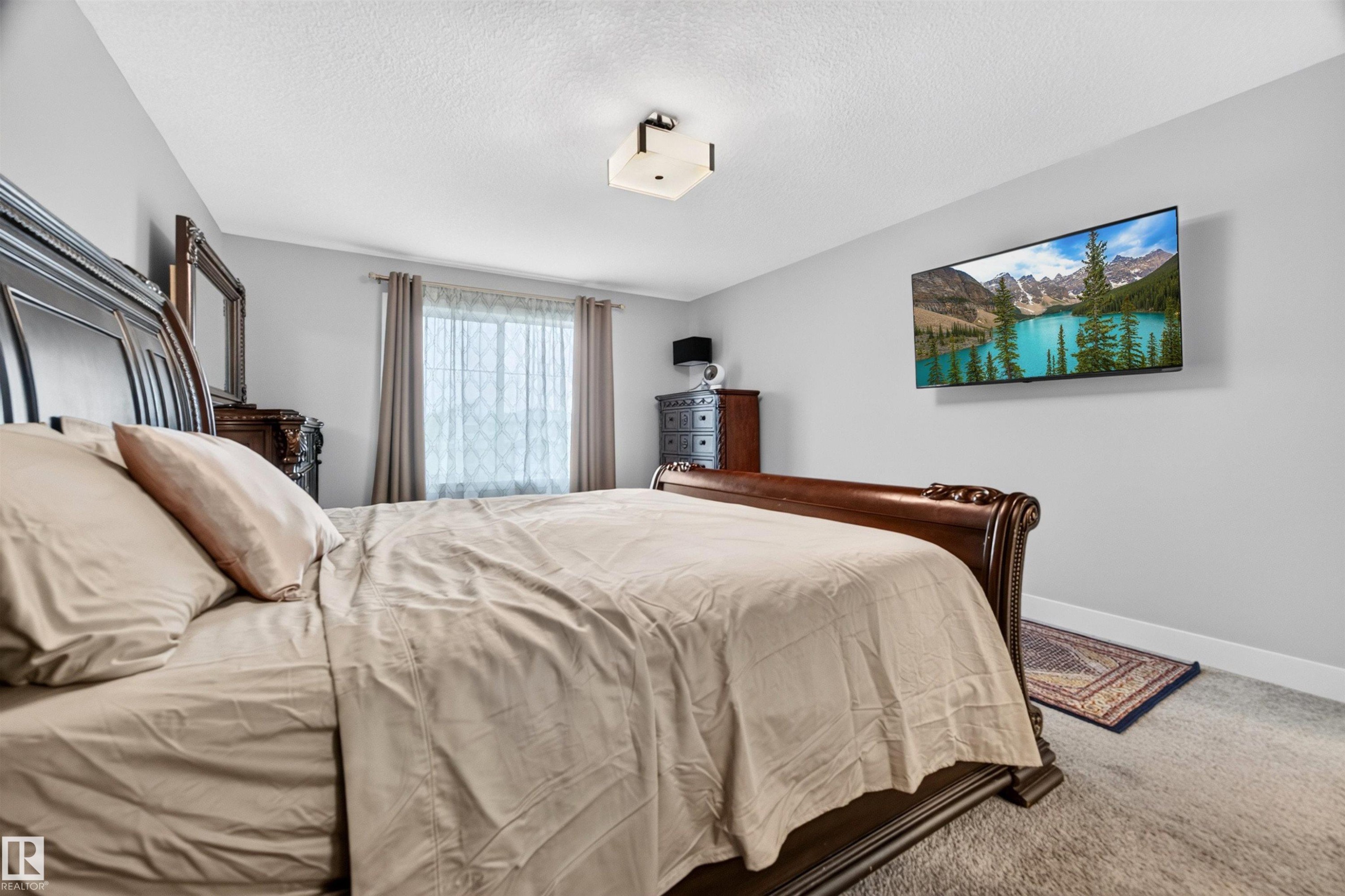 Bedroom featuring light gray walls and a window with neutral drapes - 1603 158 Street, Edmonton, AB