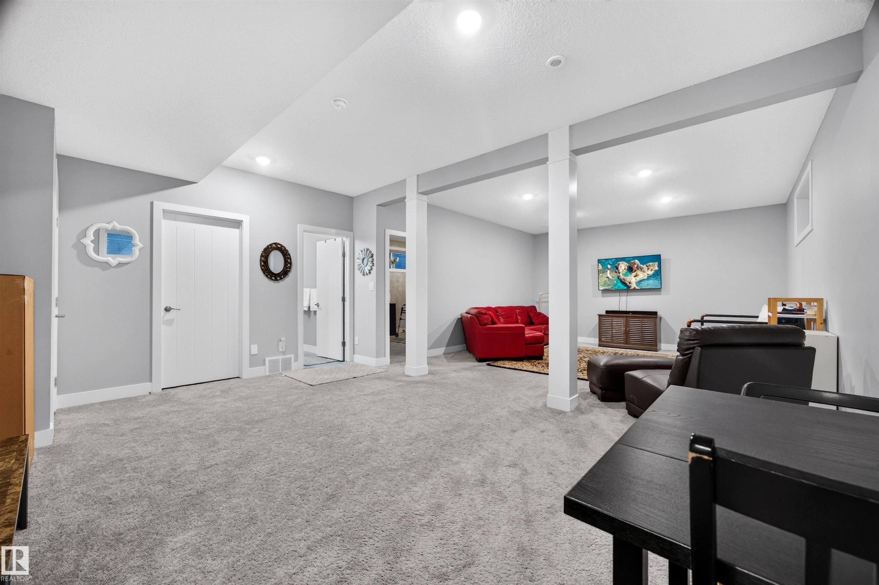 Spacious finished room featuring light gray walls, recessed lighting, and carpeted flooring - 1603 158 Street, Edmonton, AB