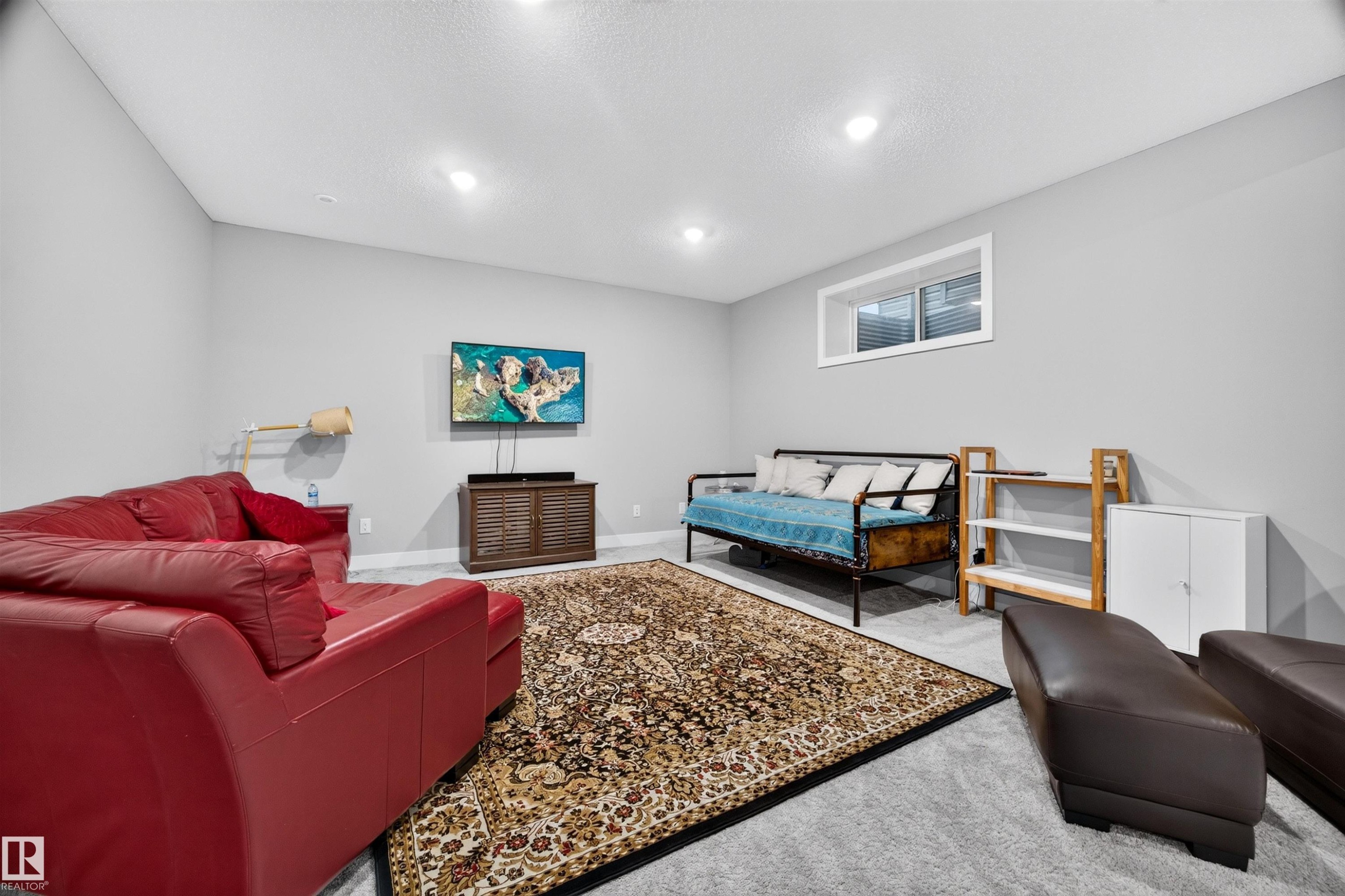 Spacious room with gray wall paint and matching carpet flooring - 1603 158 Street, Edmonton, AB