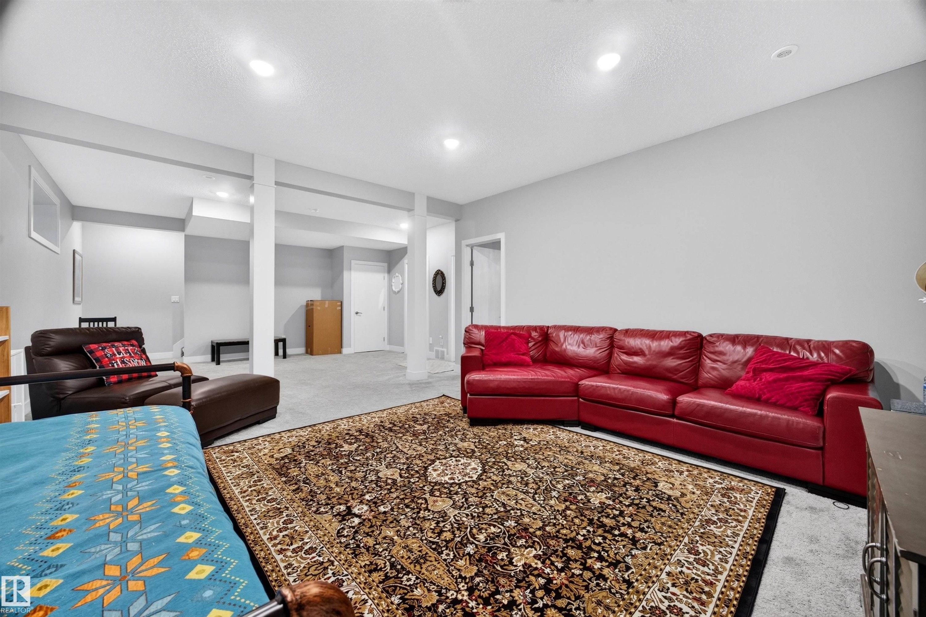 Spacious lower-level area featuring recessed lighting, light gray walls, and carpet flooring - 1603 158 Street, Edmonton, AB