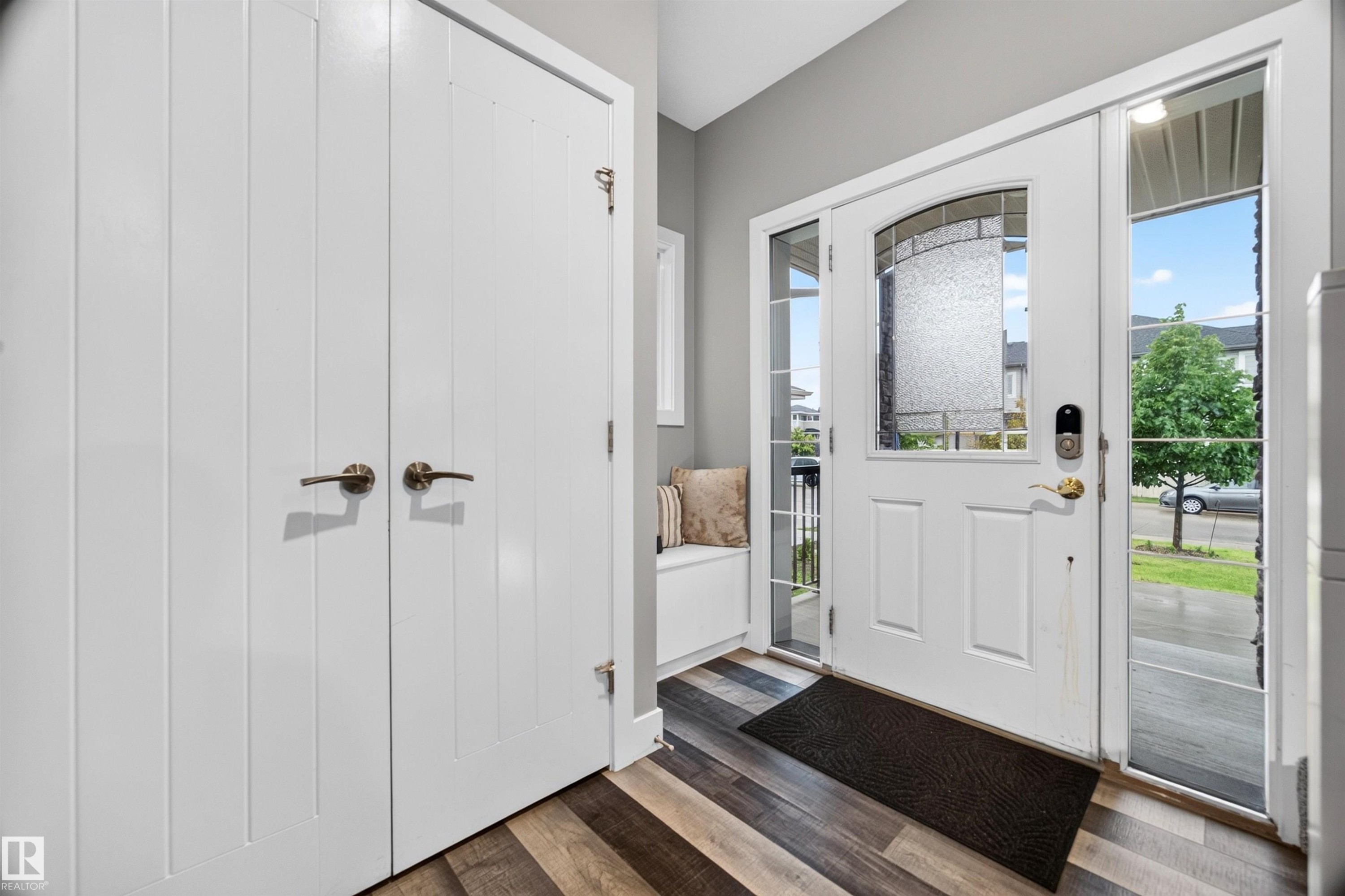 Entryway featuring a white door with decorative glass, two sidelight windows, and transom window - 1603 158 Street, Edmonton, AB