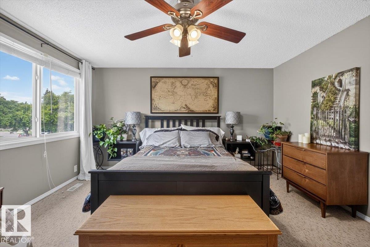 Carpeted room with neutral wall tones and a window offering exterior scenery - 27 Walden Park, St. Albert, AB