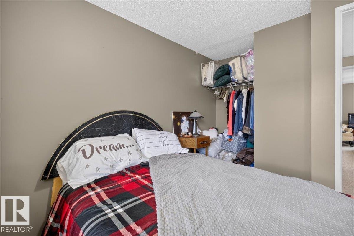 Recessed closet with hanging rod and upper shelf storage - 27 Walden Park, St. Albert, AB