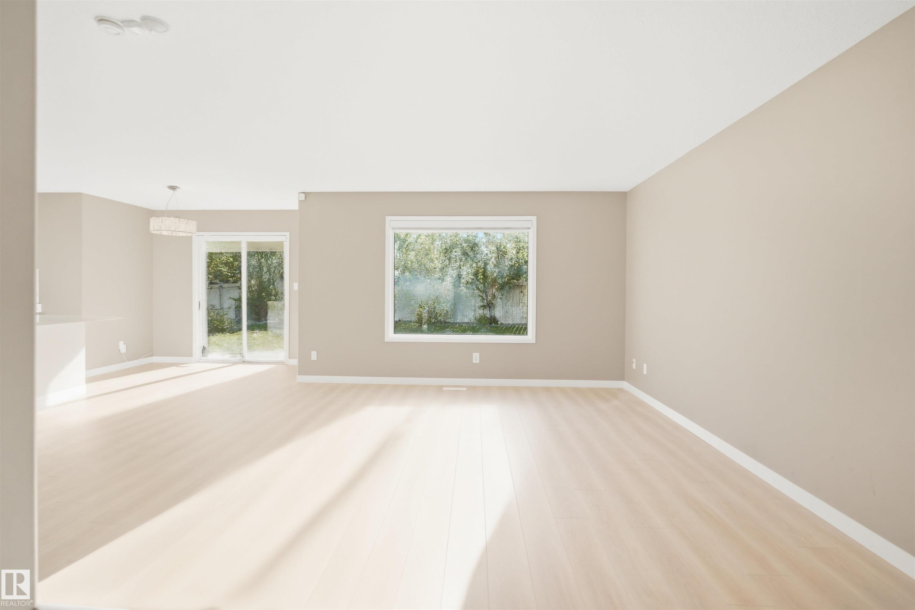 Bright, open-concept living space with light wood-finish flooring - 2610 33A Street, Edmonton, AB - Indoor Photo Showing Other Room