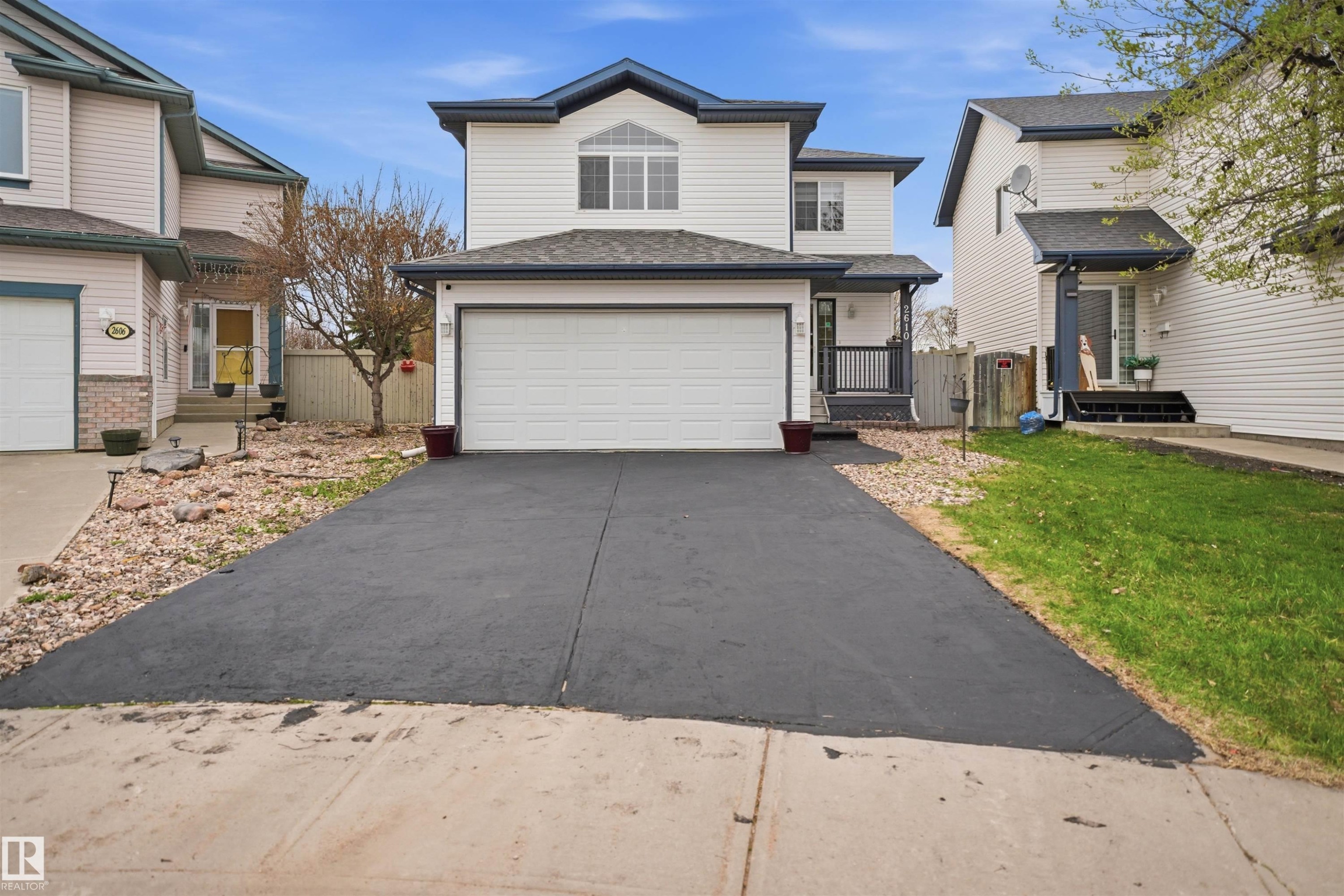 Two-story residence featuring white siding and dark trim accents - 2610 33A Street, Edmonton, AB -