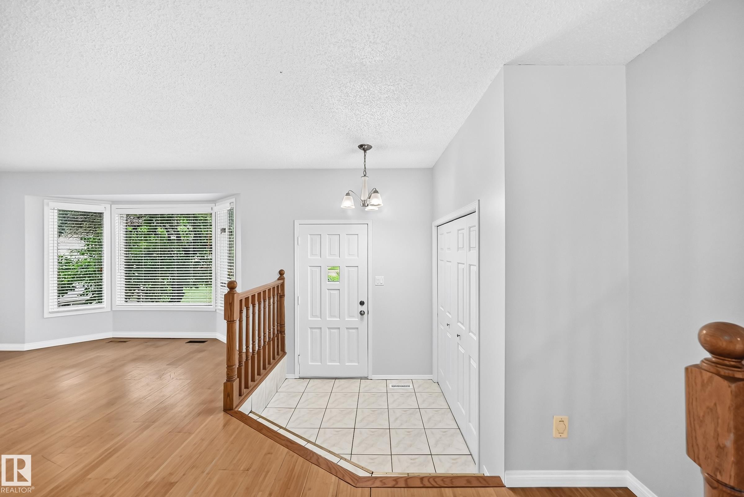 Entry foyer with tile flooring and a multi-paneled door - 9843 188 Street, Edmonton, AB