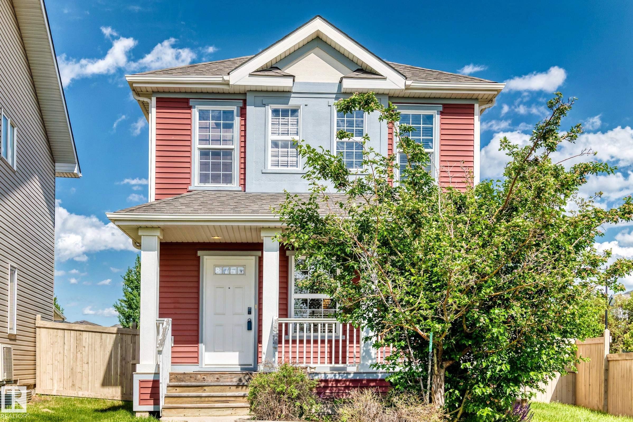 Two-story residence featuring red siding and light blue stucco accents - 875 Chappelle Link Link Sw, Edmonton, AB