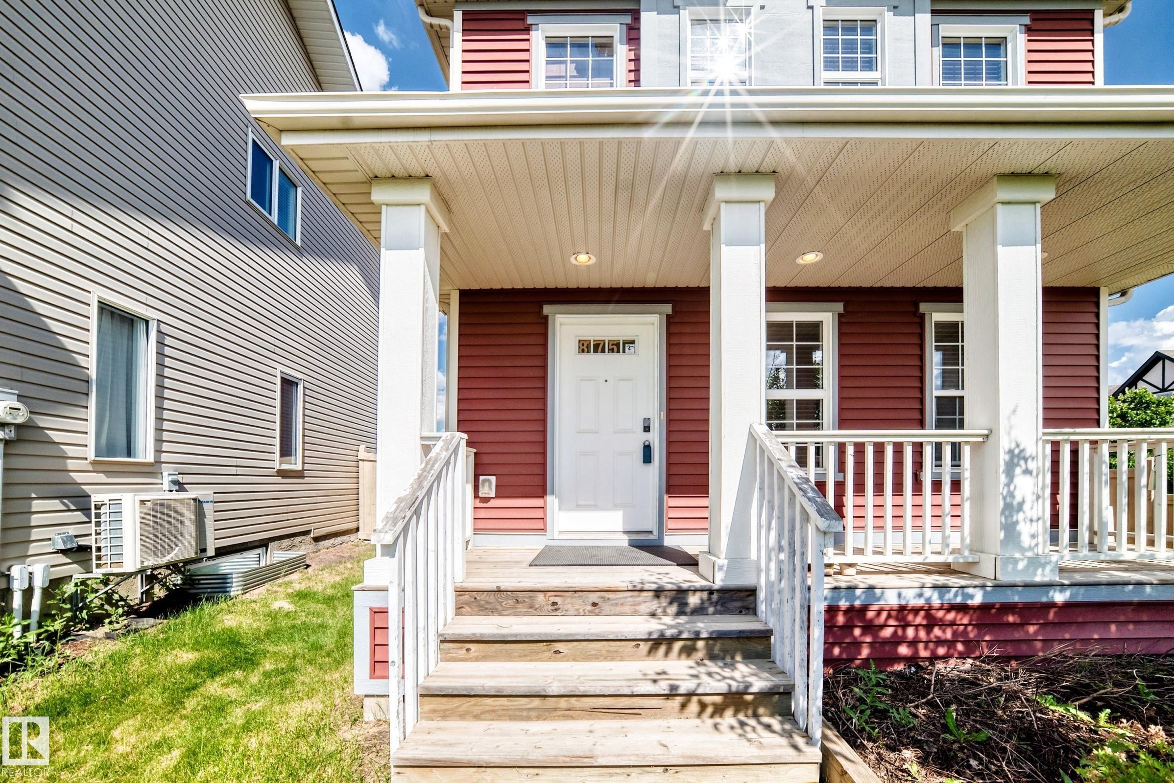 Inviting front porch with white railings and columns - 875 Chappelle Link Link Sw, Edmonton, AB