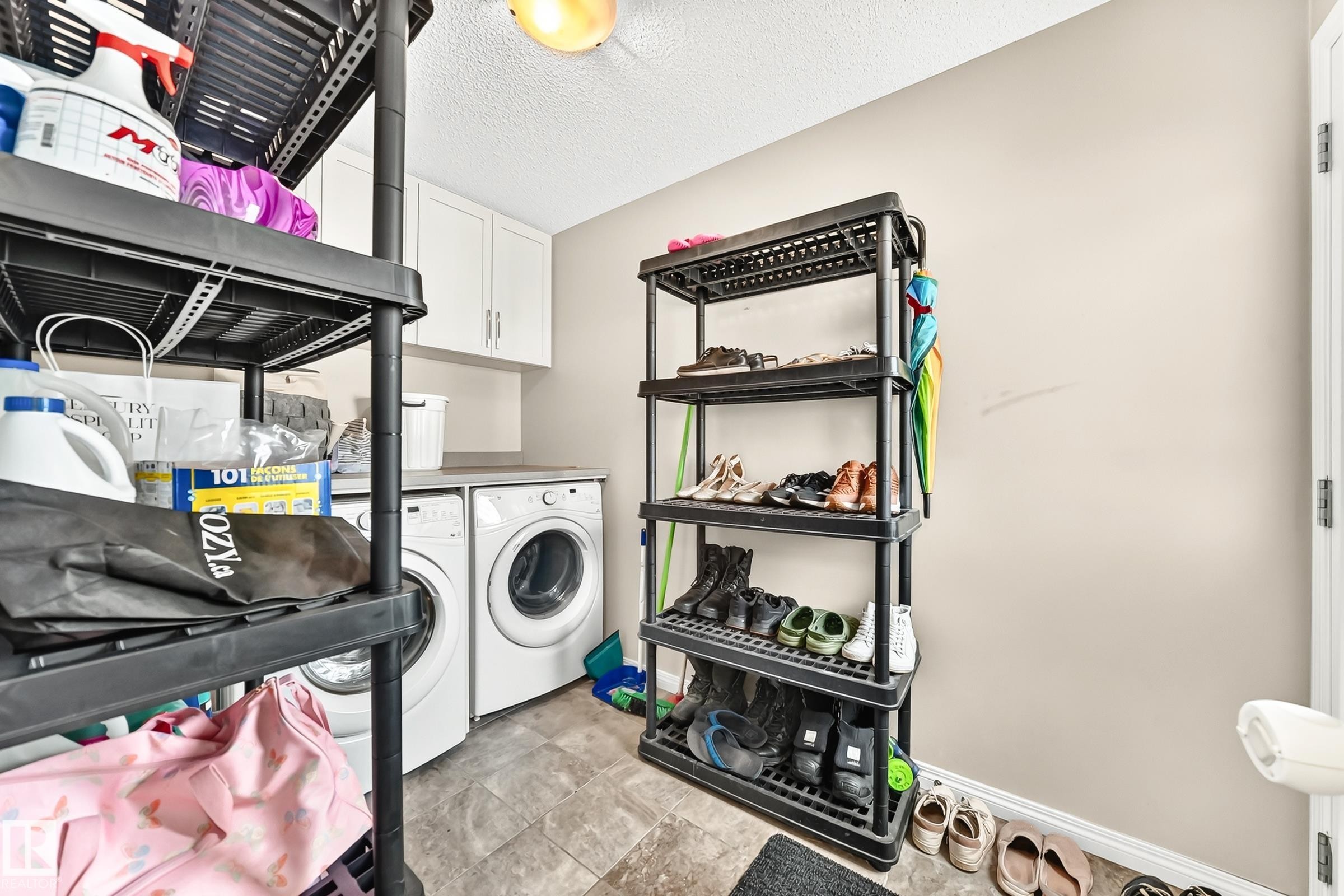 Laundry area with white upper cabinetry and a light-colored countertop - 875 Chappelle Link Link Sw, Edmonton, AB