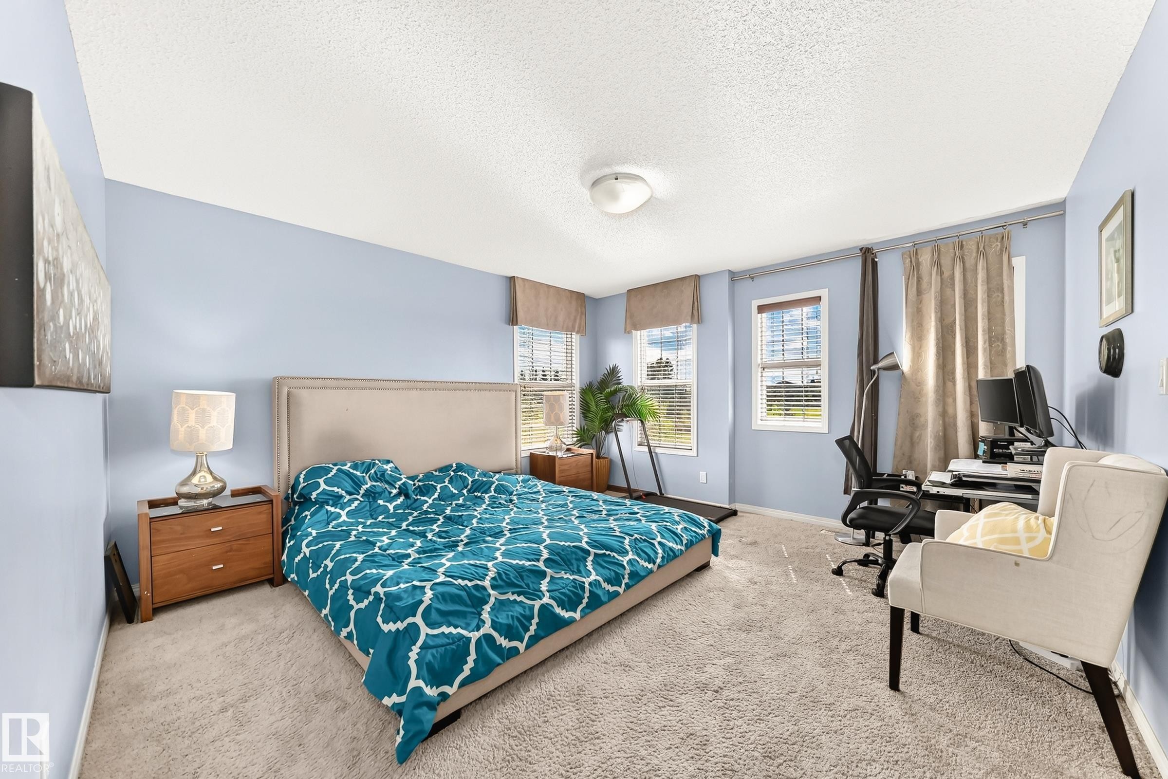 Spacious bedroom featuring light blue walls and plush carpeting - 875 Chappelle Link Link Sw, Edmonton, AB