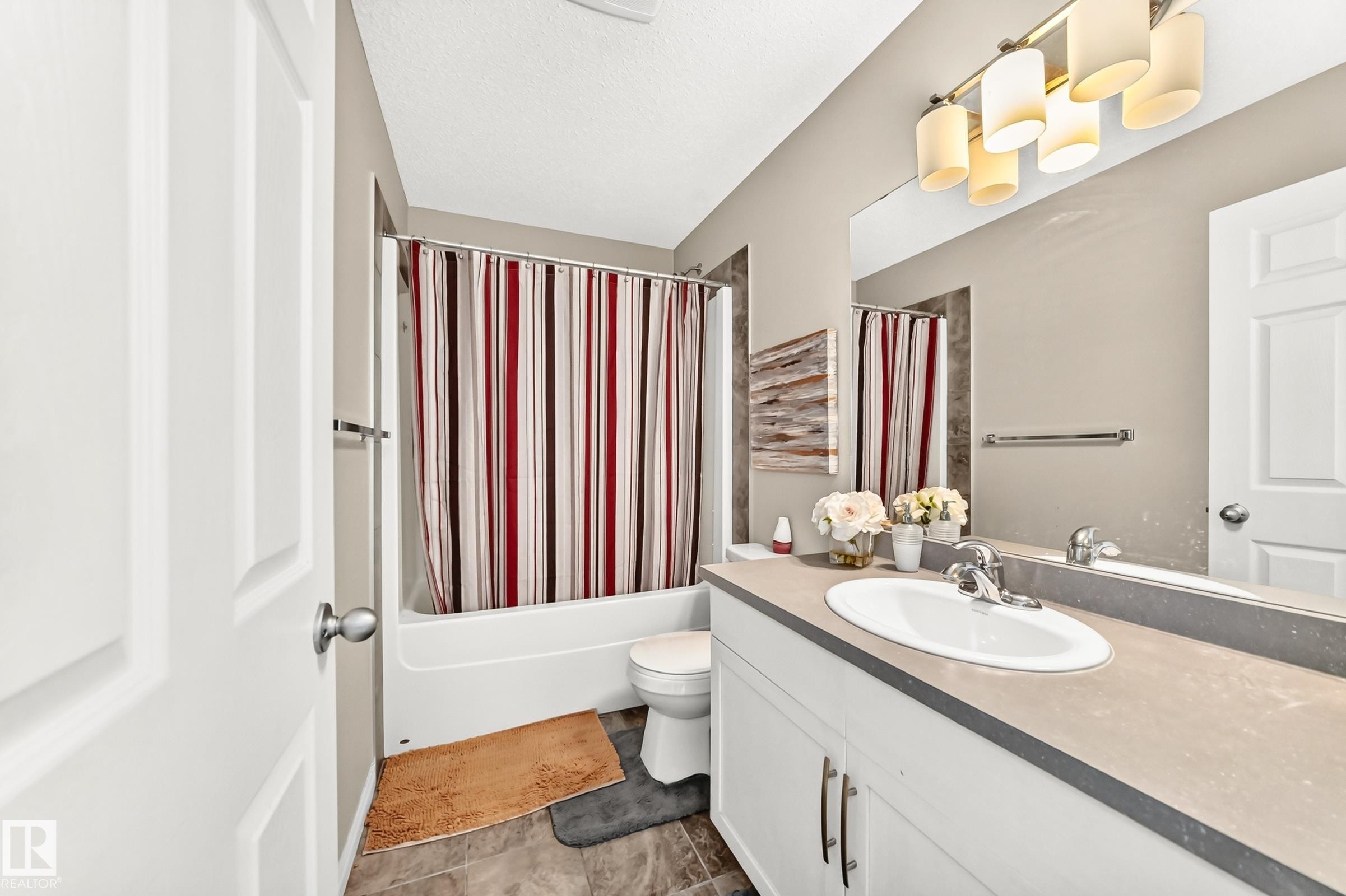 Full bathroom featuring a white vanity with a single basin sink and a neutral-toned countertop - 875 Chappelle Link Link Sw, Edmonton, AB