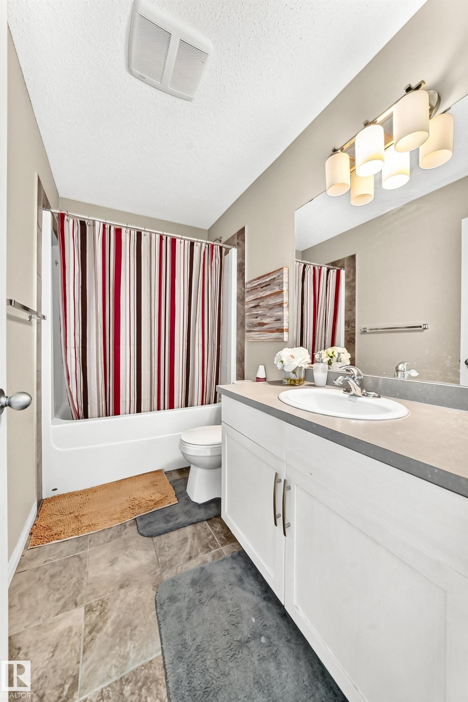 Bathroom featuring a white vanity with double doors and silver hardware, a single basin sink, and a gray countertop - 875 Chappelle Link Link Sw, Edmonton, AB