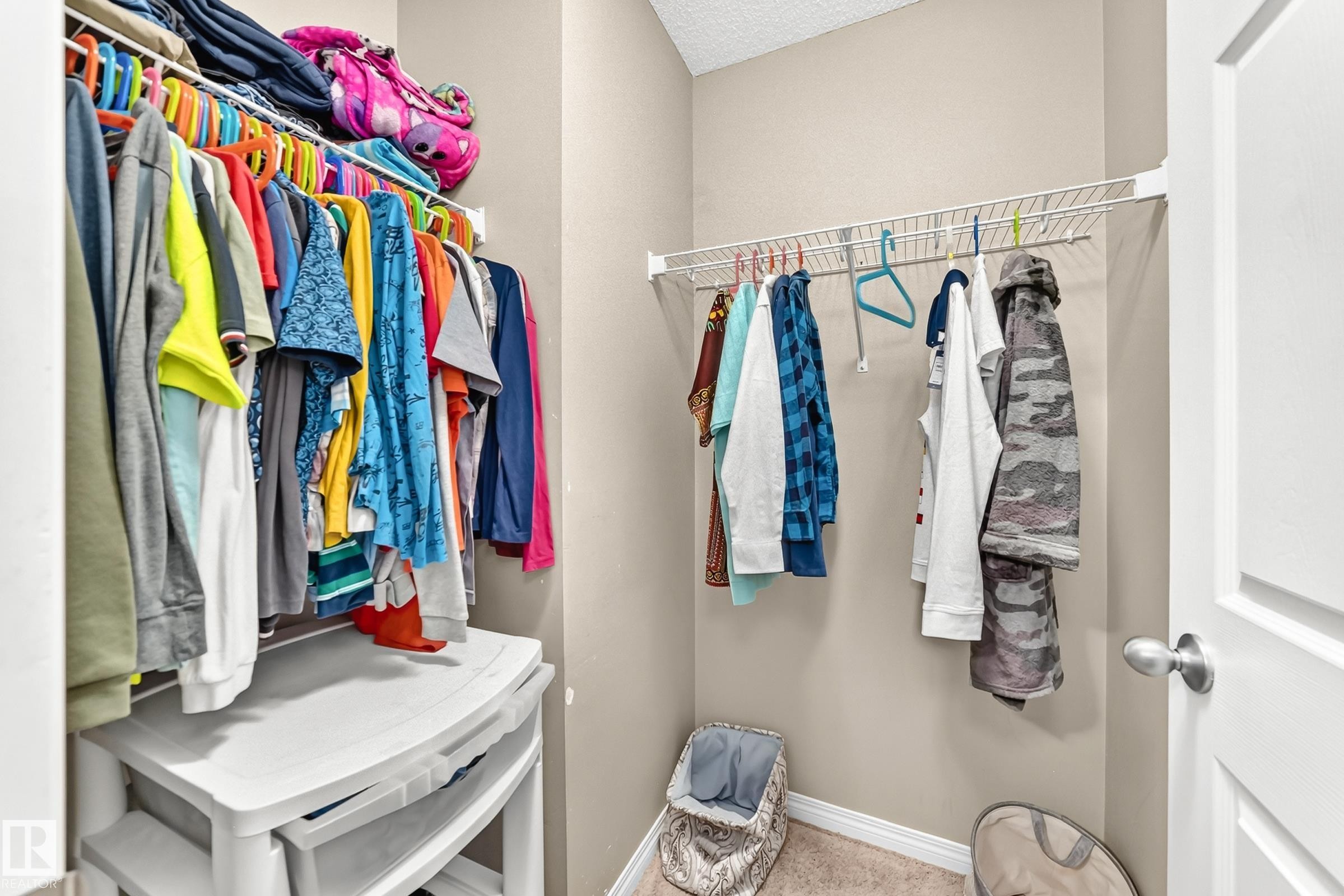 Walk-in closet featuring wire shelving and carpet flooring - 875 Chappelle Link Link Sw, Edmonton, AB