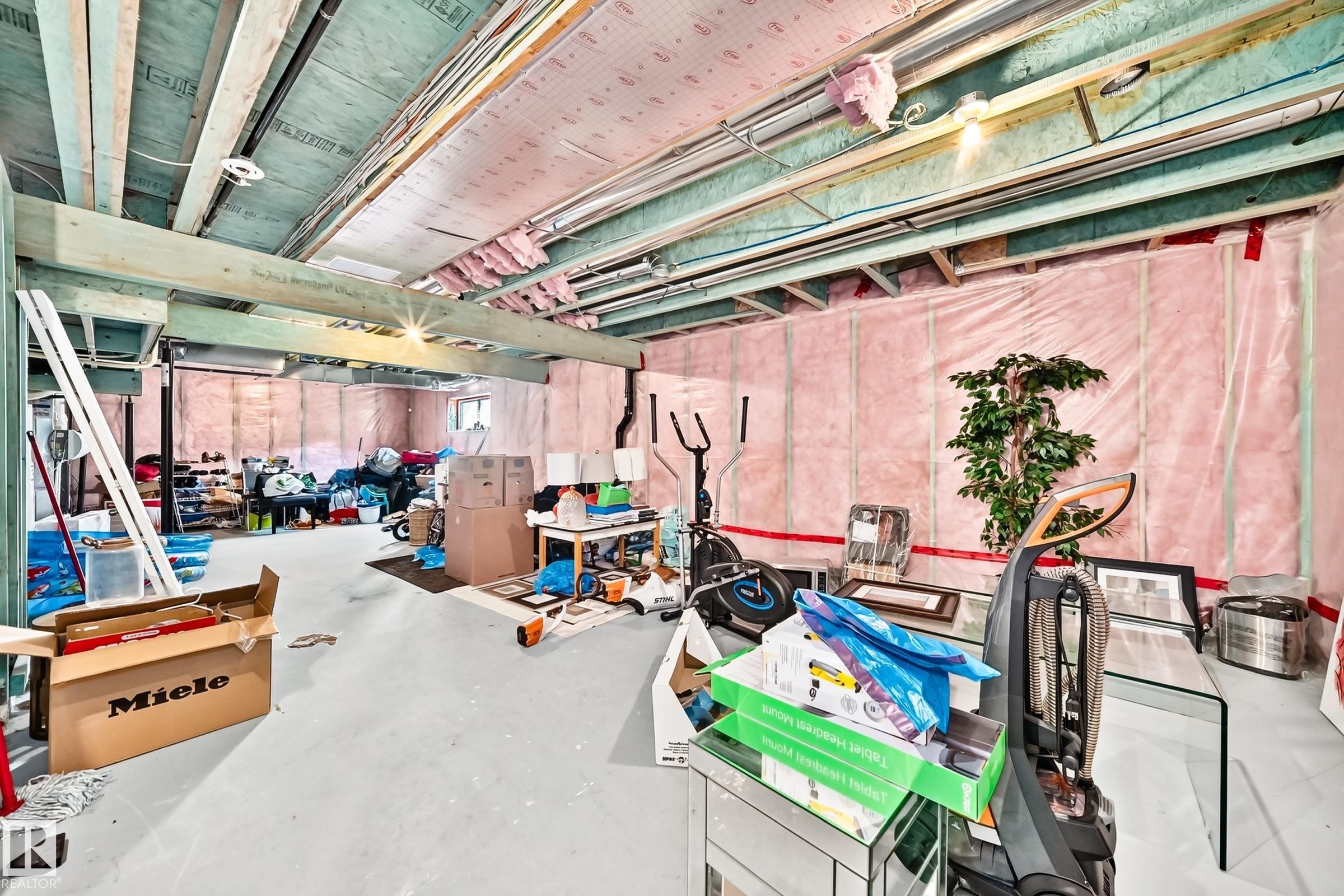 Unfinished basement with exposed ceiling joists, concrete flooring, and insulated walls - 875 Chappelle Link Link Sw, Edmonton, AB
