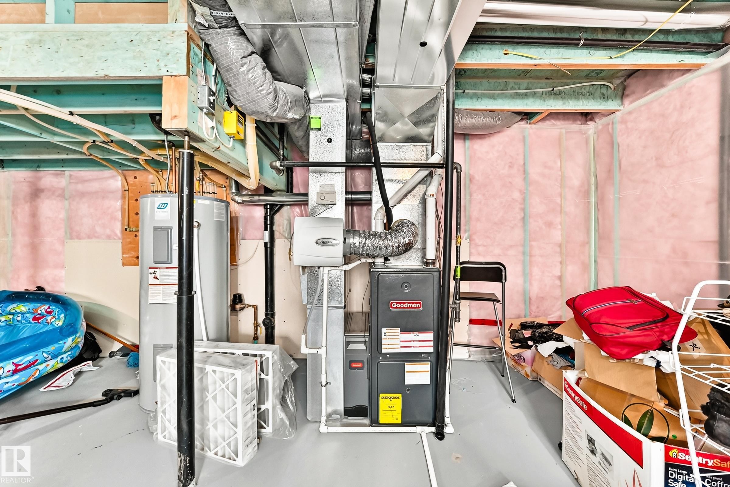Mechanical room featuring a furnace, water heater, and exposed ductwork - 875 Chappelle Link Link Sw, Edmonton, AB