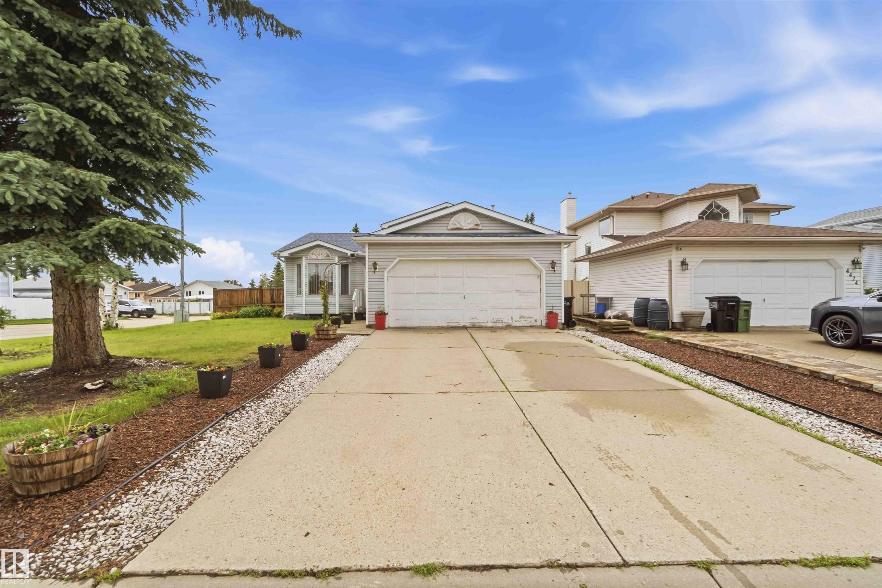 Single-story residence featuring light-colored siding and an attached two-car garage - 4428 11A Avenue Nw, Edmonton, AB - Outdoor