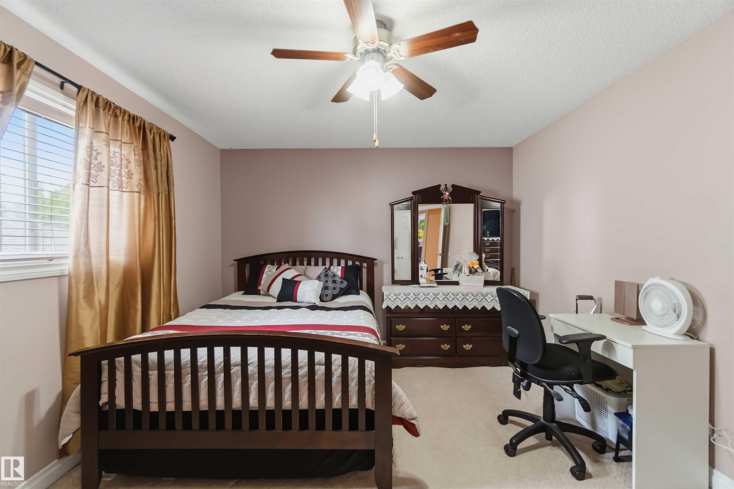 Carpeted room with a ceiling fan light fixture and a window with blinds - 4428 11A Avenue Nw, Edmonton, AB - Indoor Photo Showing Bedroom