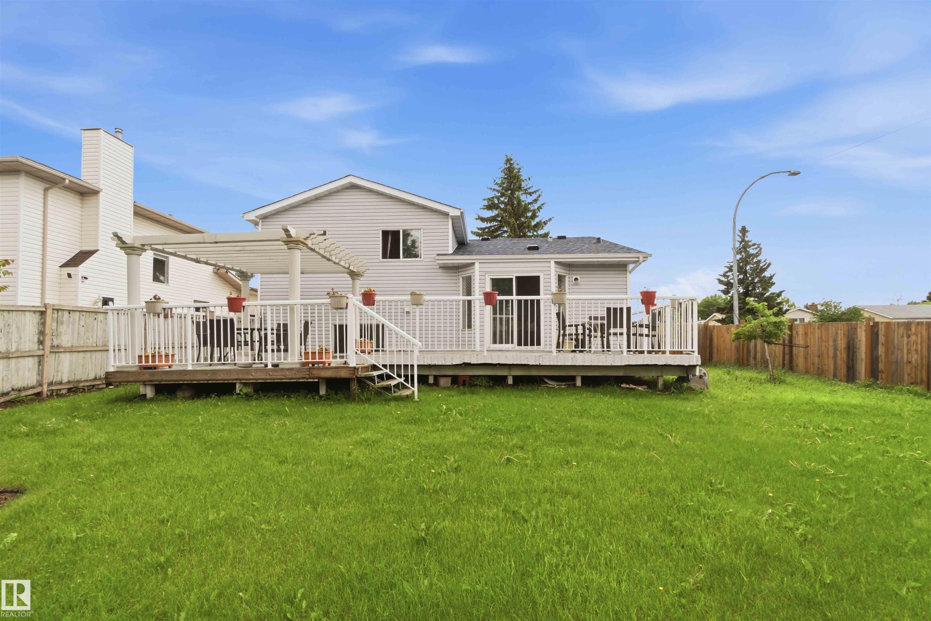 Expansive green lawn providing ample outdoor space - 4428 11A Avenue Nw, Edmonton, AB - Outdoor With Deck Patio Veranda With Backyard With Exterior