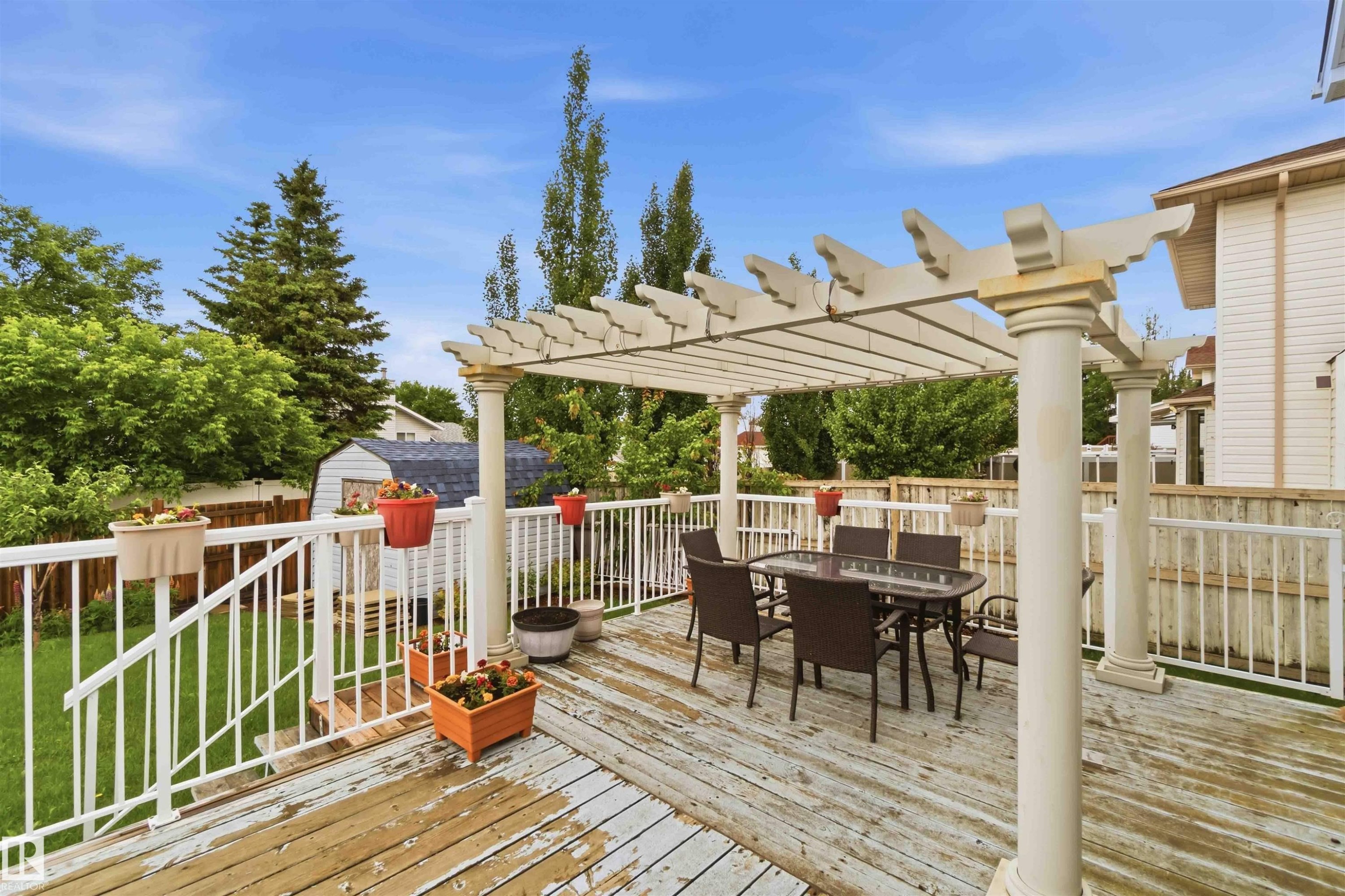 Expansive wood deck featuring a decorative pergola - 4428 11A Avenue Nw, Edmonton, AB - Outdoor With Deck Patio Veranda With Exterior