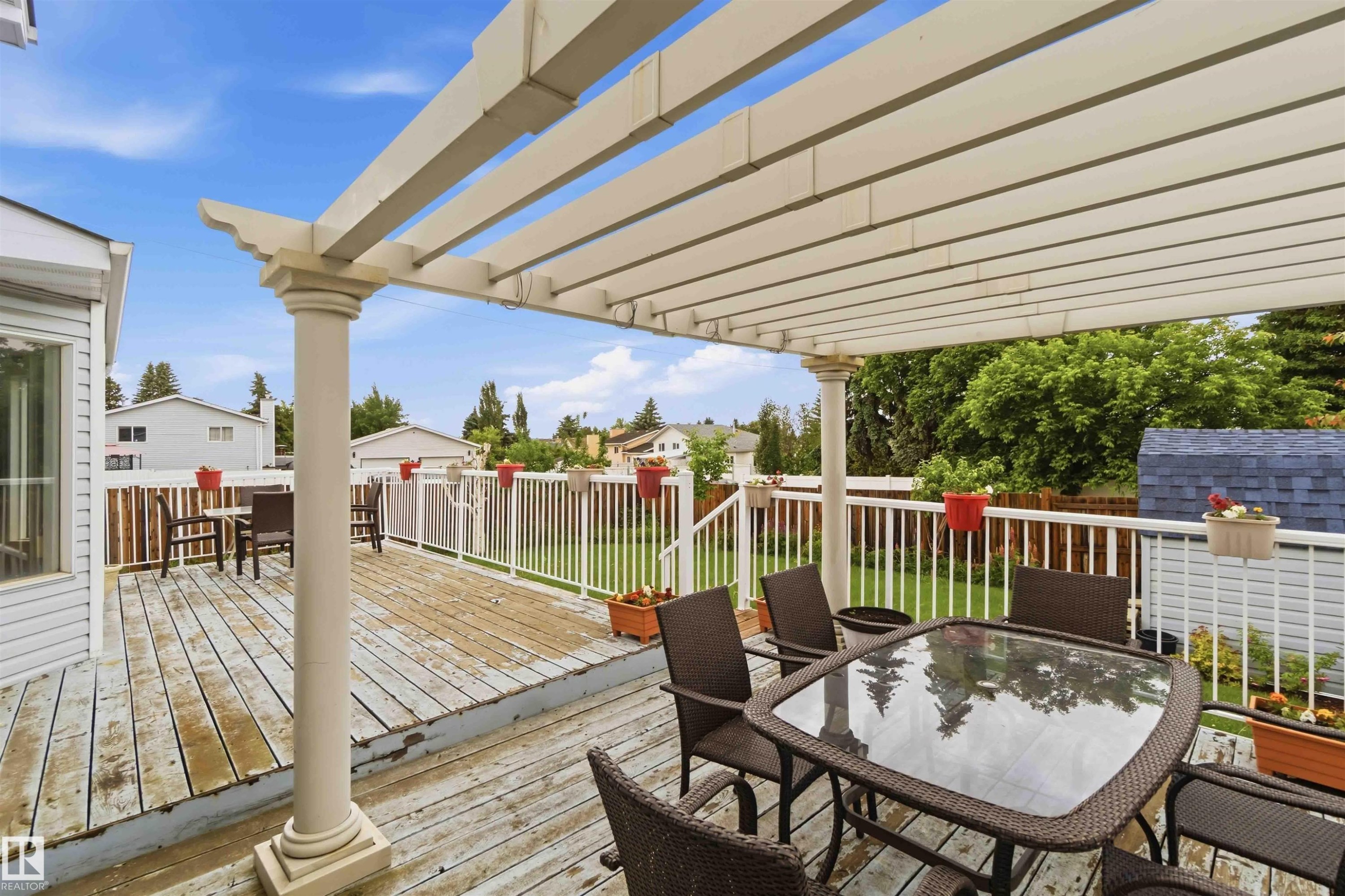 Expansive wood-finish deck featuring a decorative pergola - 4428 11A Avenue Nw, Edmonton, AB - Outdoor With Deck Patio Veranda With Exterior