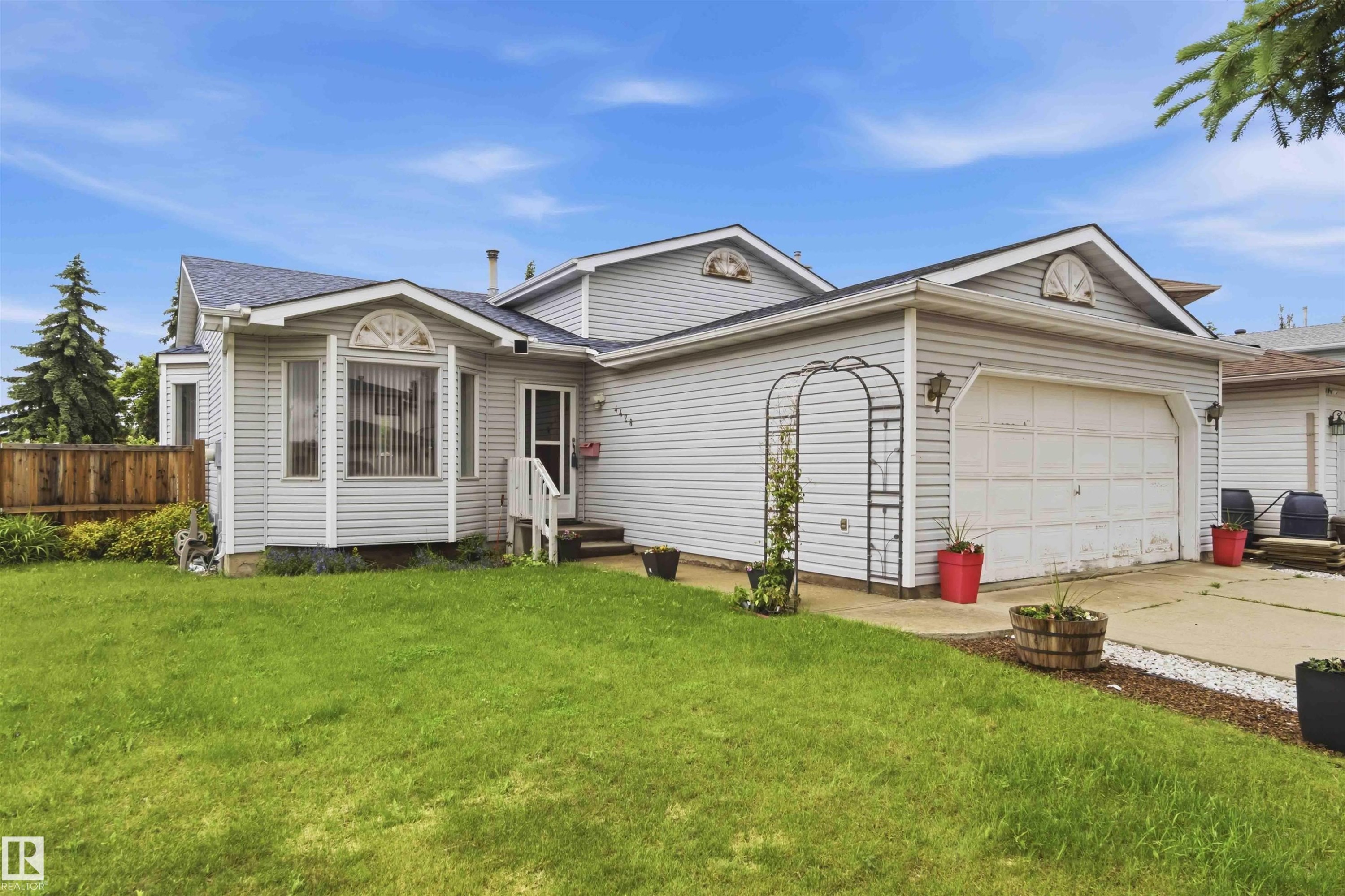 Exterior featuring light gray siding and a dark shingled roof - 4428 11A Avenue Nw, Edmonton, AB - Outdoor