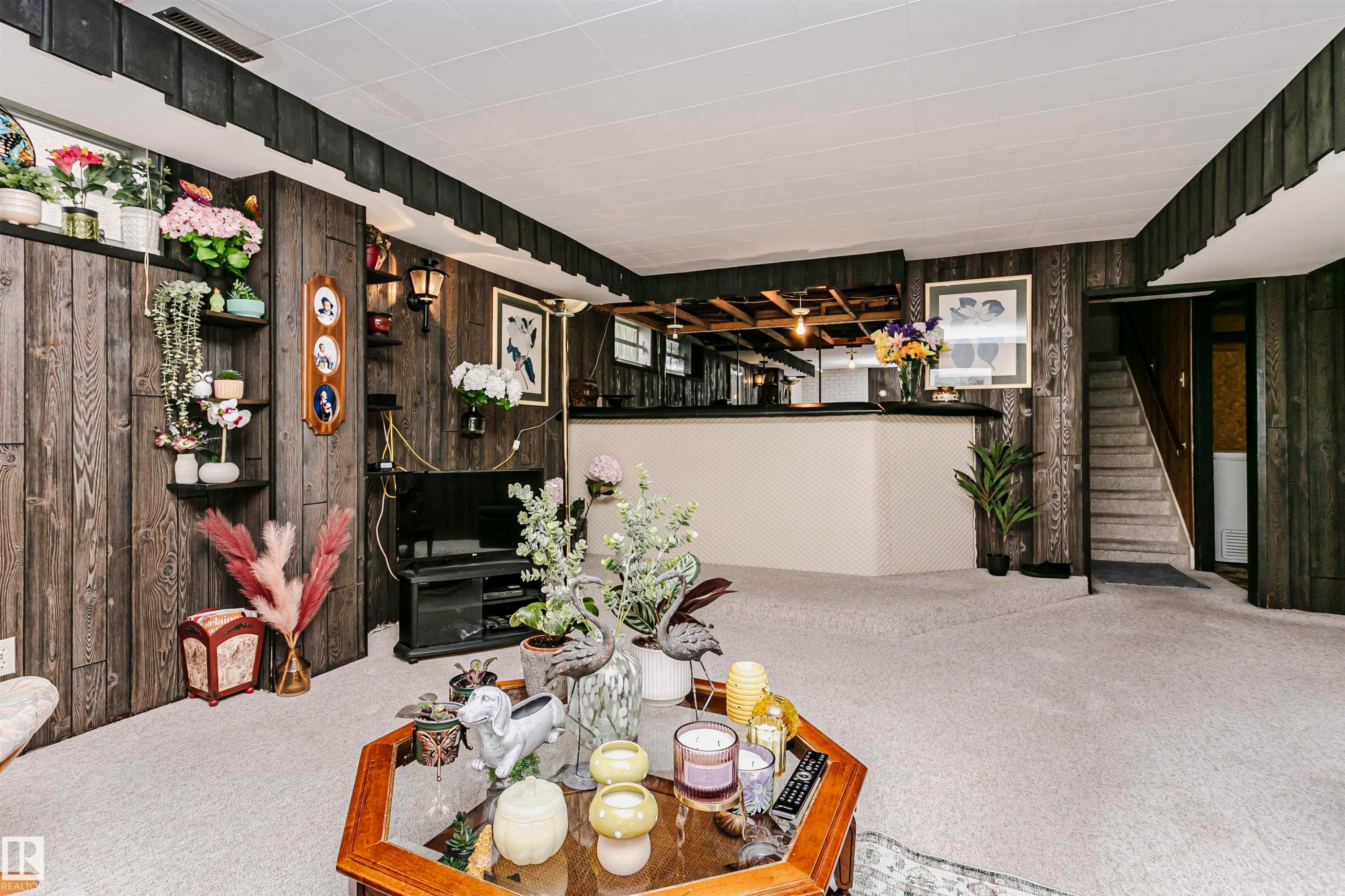 Recreational room featuring wood-finish wall paneling and light-toned carpeting - 14231 80 Street, Edmonton, AB