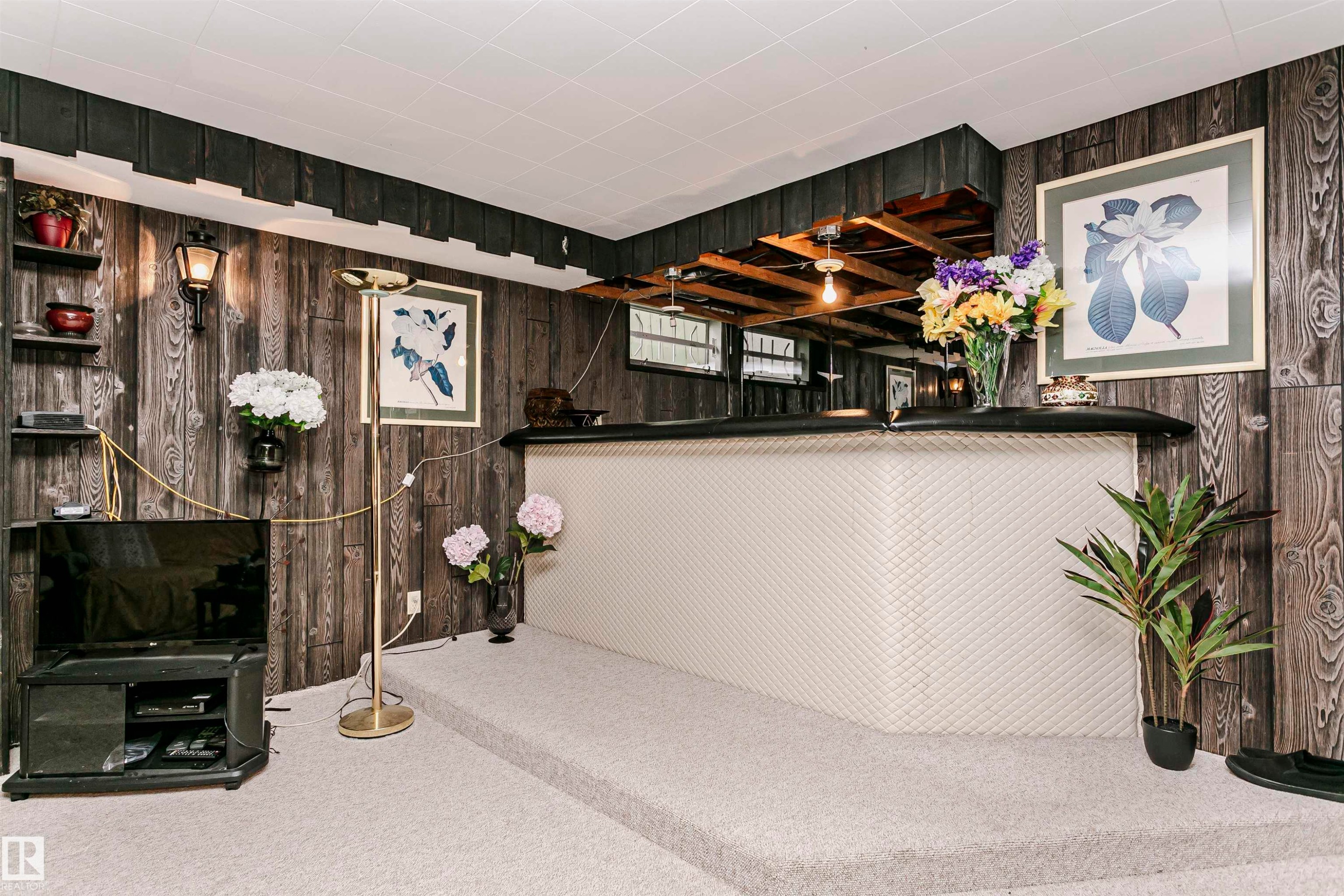 Built-in entertainment bar with textured paneling, a dark countertop, and mirrored backsplash - 14231 80 Street, Edmonton, AB