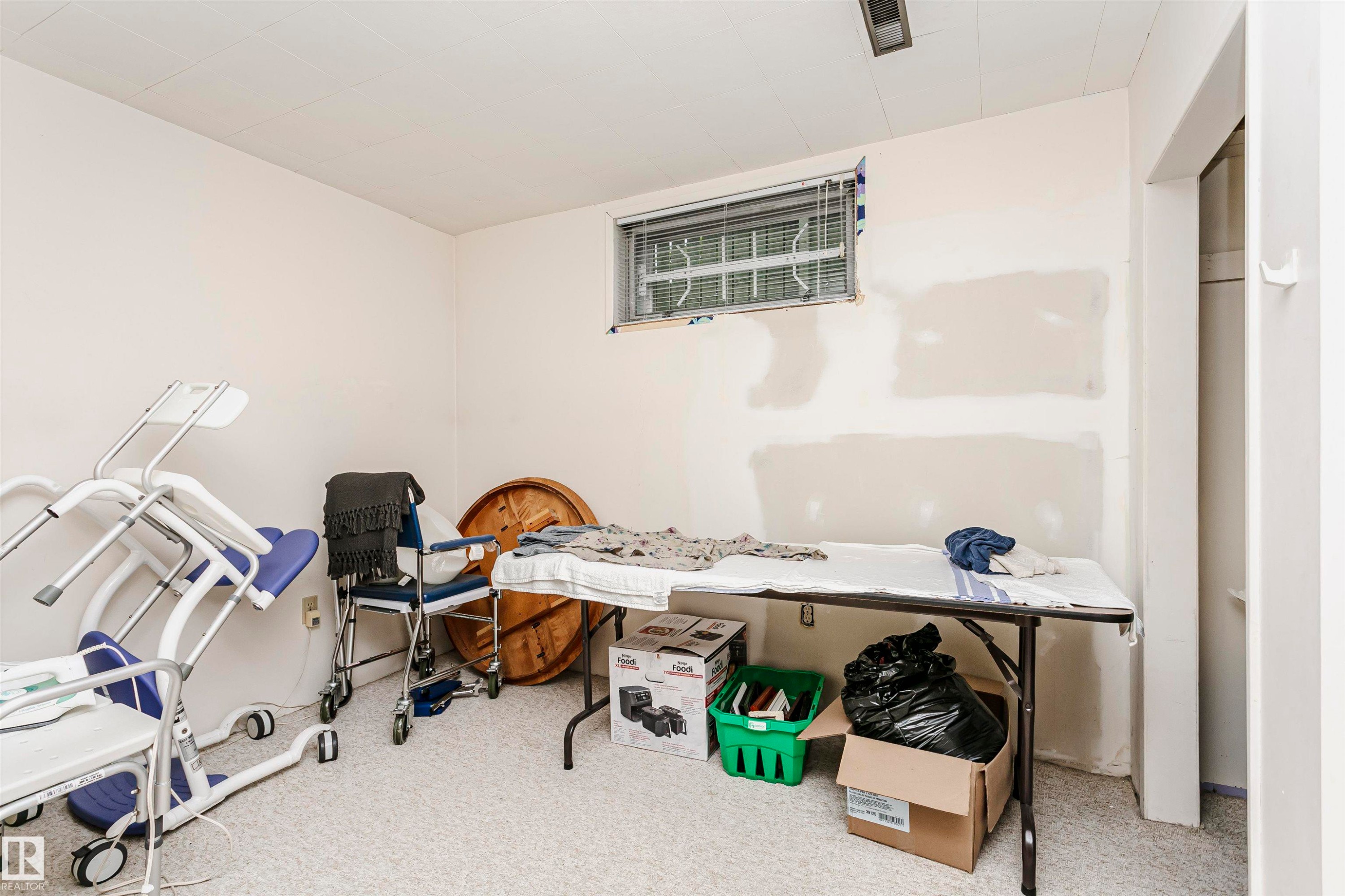 Room featuring light-colored walls, a window with horizontal blinds, and a white ceiling - 14231 80 Street, Edmonton, AB