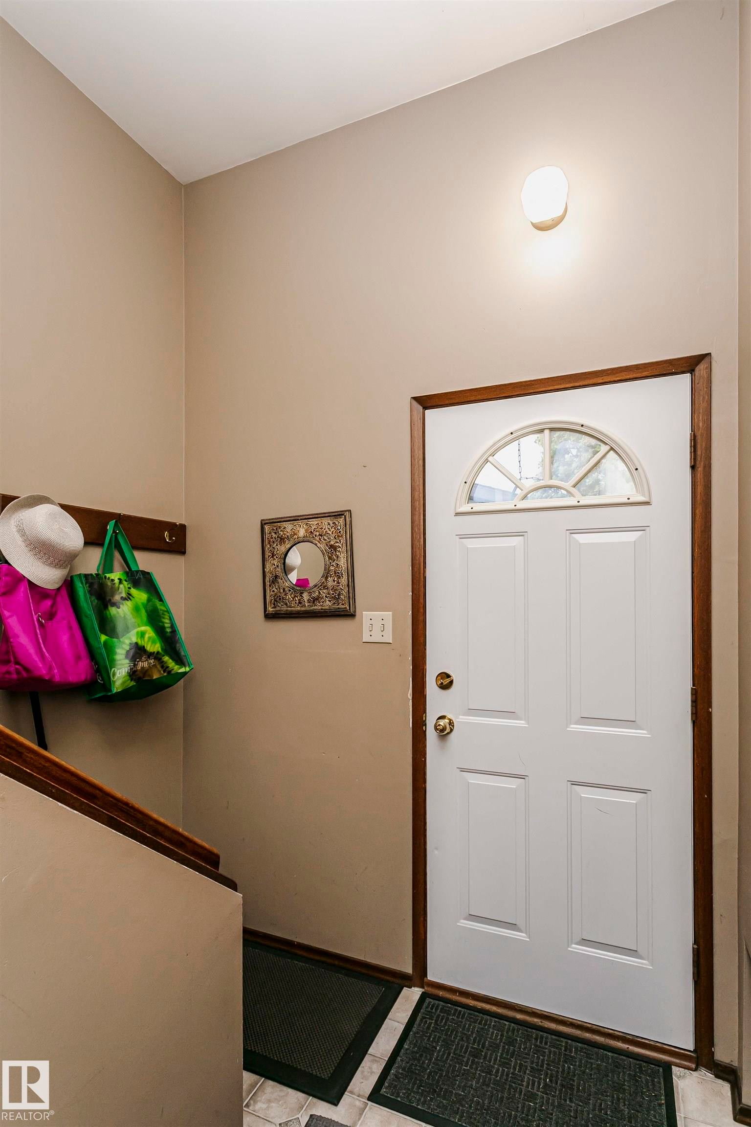 Entryway featuring a paneled white door with an arched transom window - 14231 80 Street, Edmonton, AB