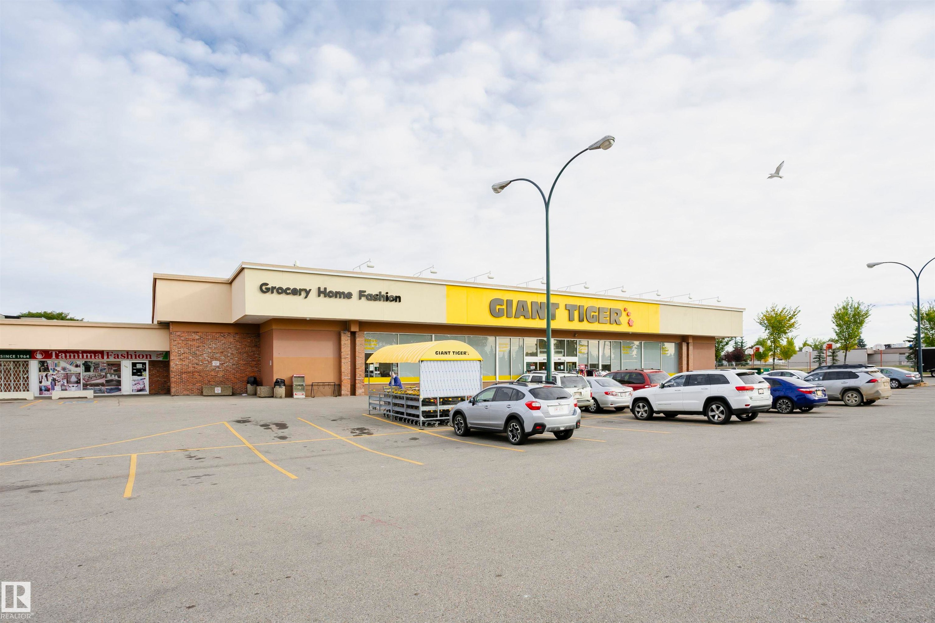 Retail building featuring a brick facade and prominent signage - 14231 80 Street, Edmonton, AB